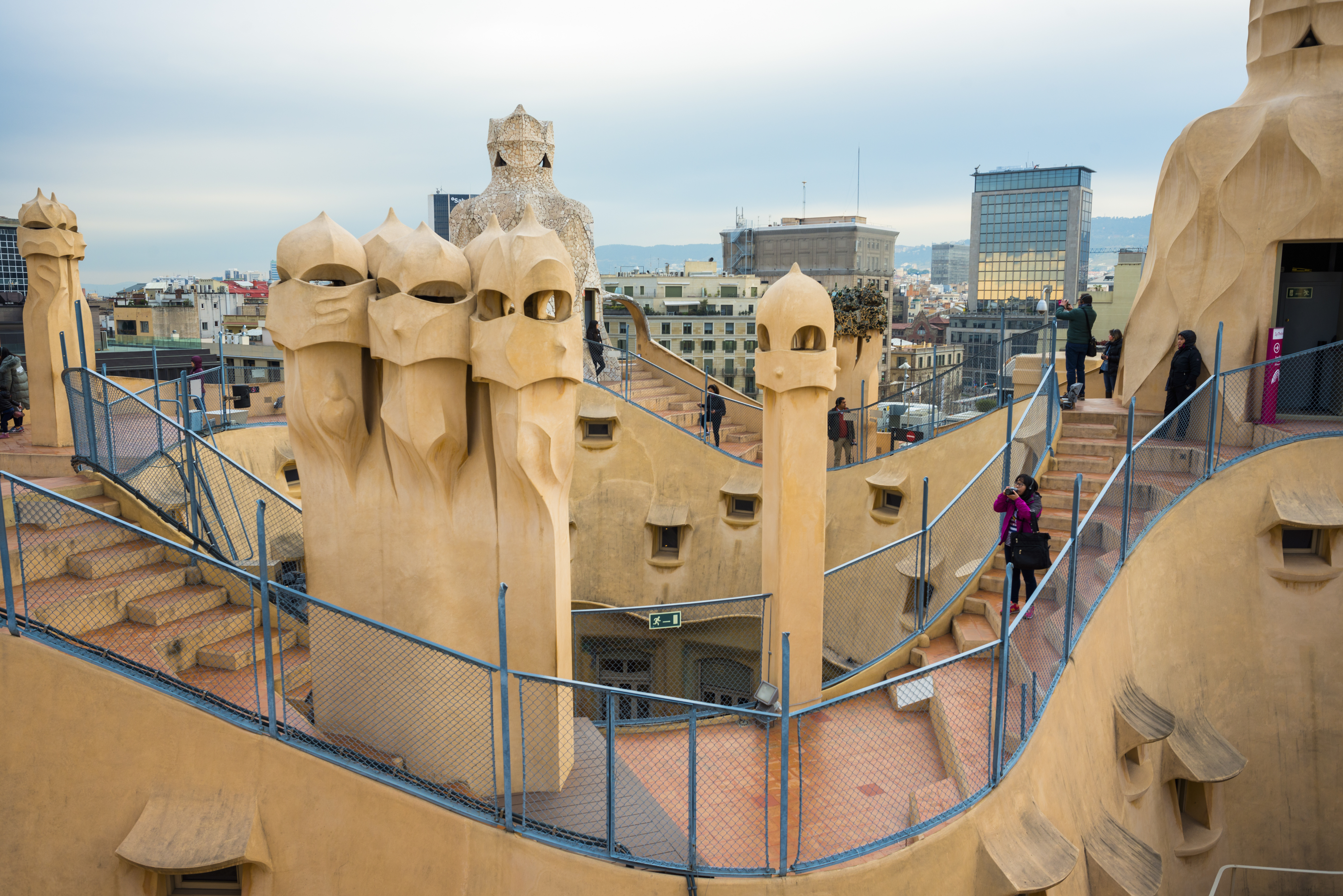 Barcelona, Guadi’s The Pedrera (Casa Mila) on the roof with its unusual chimneys, Catalonia, Spain
