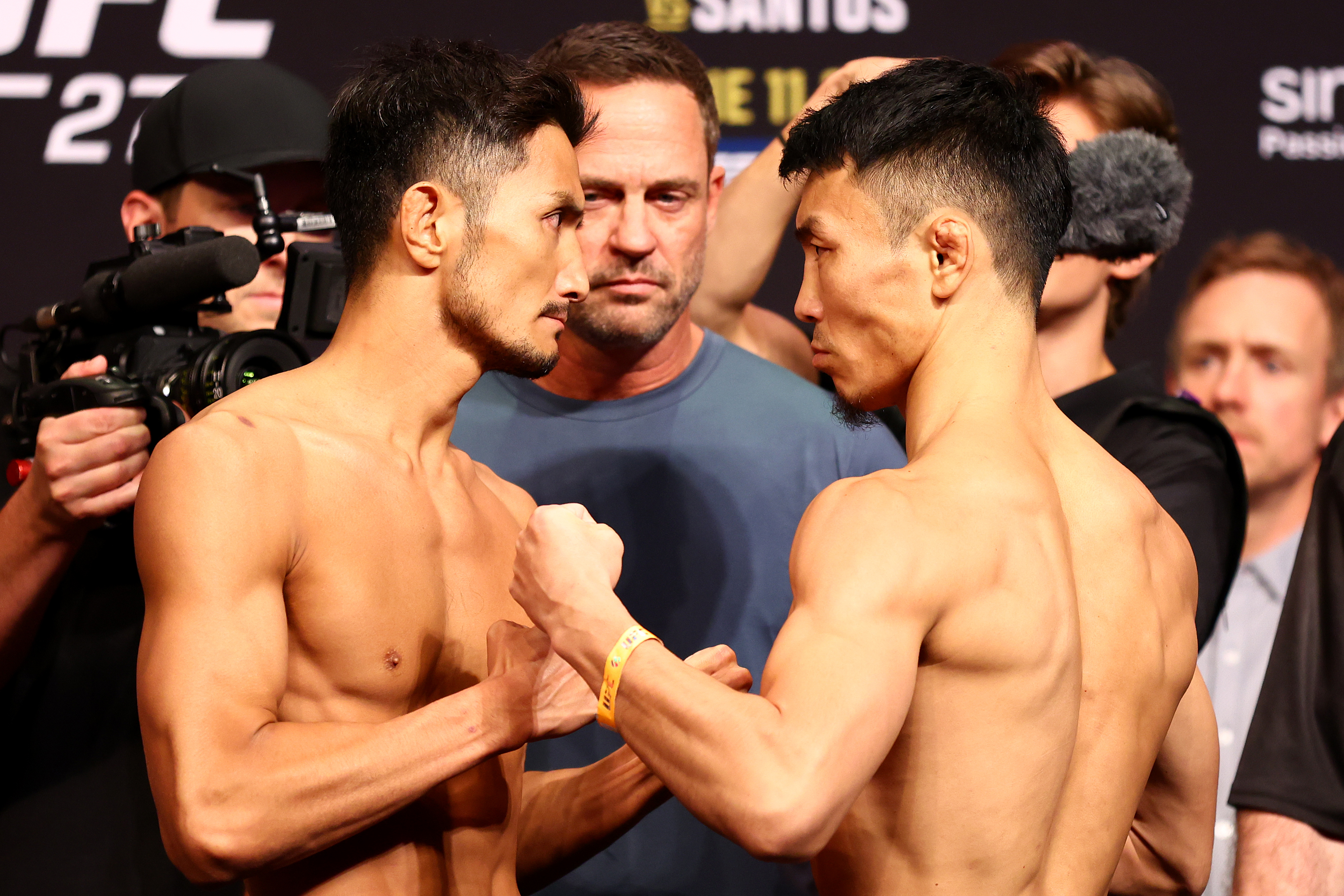 Kyung Ho Kang of South Korea and Danaa Batgerel of Mongolia face off ahead of their bantamweight bout during the UFC 275 Weigh-in at Singapore Indoor Stadium on June 10, 2022 in Singapore.