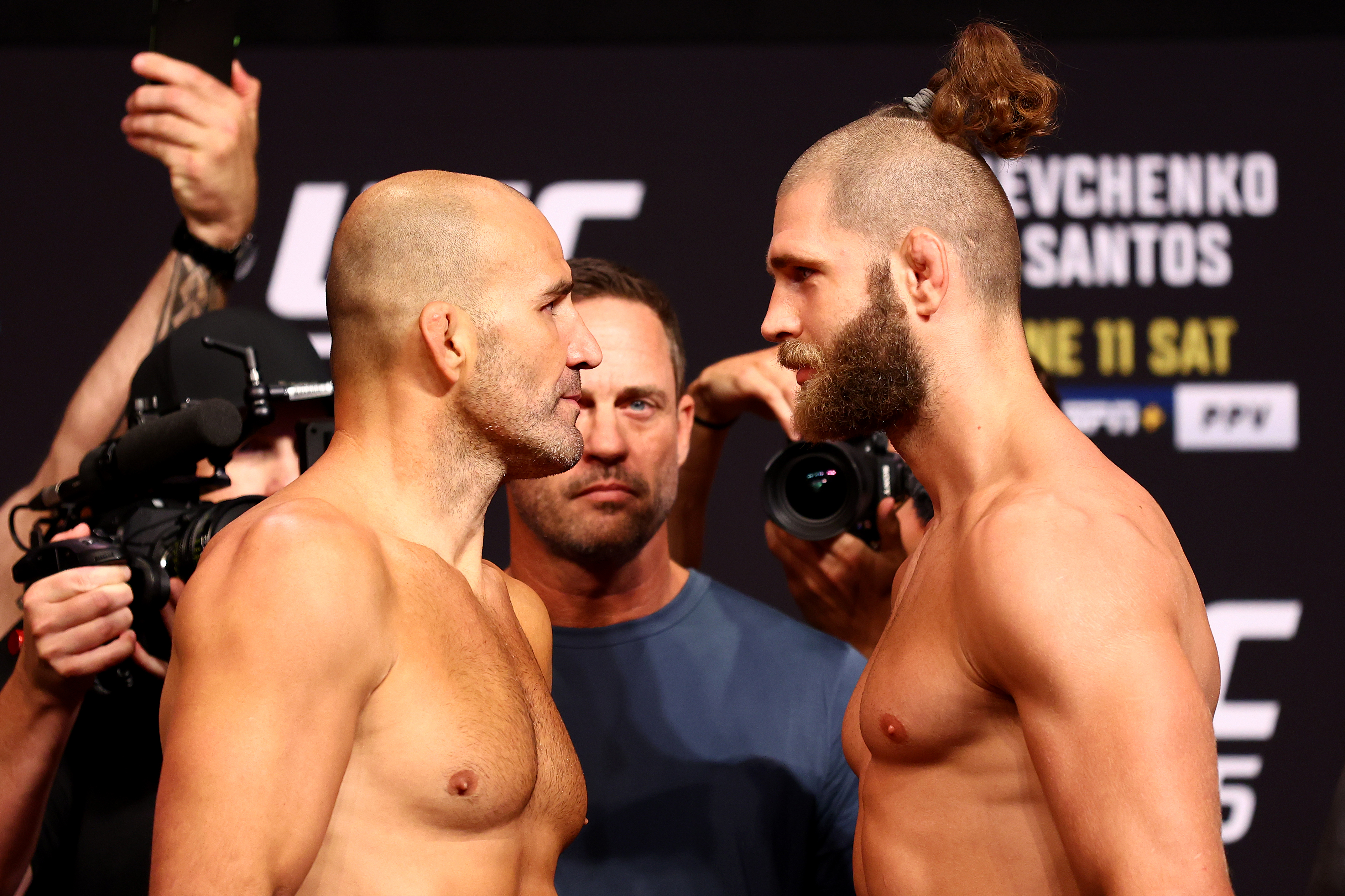 UFC light heavyweight champion Glover Texeira (L) of Brazil and Jiri Prochazka of the Czech Republic face off ahead of their title bout during the UFC 275 Weigh-in at Singapore Indoor Stadium on June 10, 2022 in Singapore.