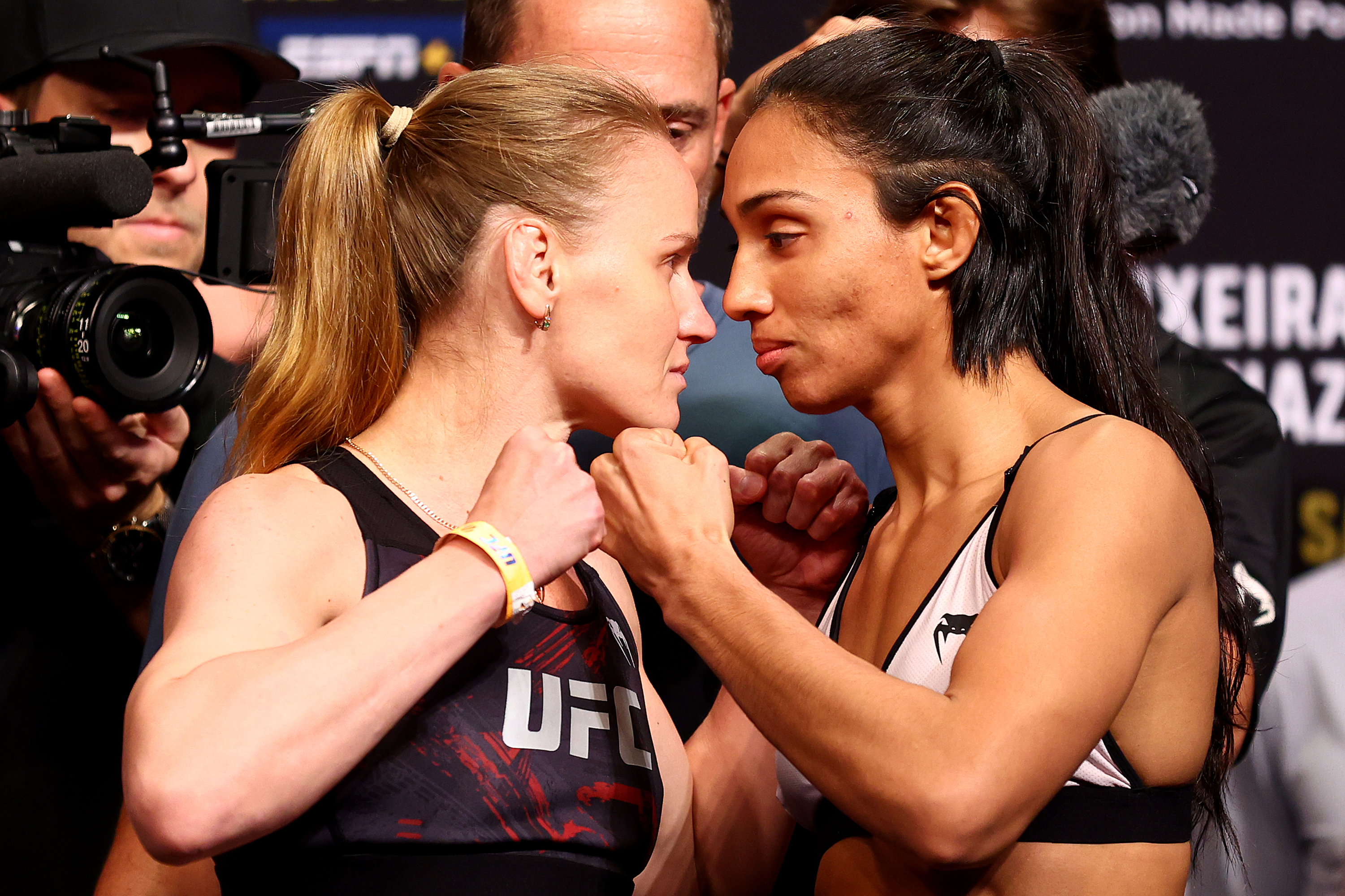 UFC flyweight champion Valentina Shevchenko (L) of Kyrgyzstan and Taila Santos of Brazil face off ahead of their title bout during the UFC 275 Weigh-in at Singapore Indoor Stadium on June 10, 2022 in Singapore.