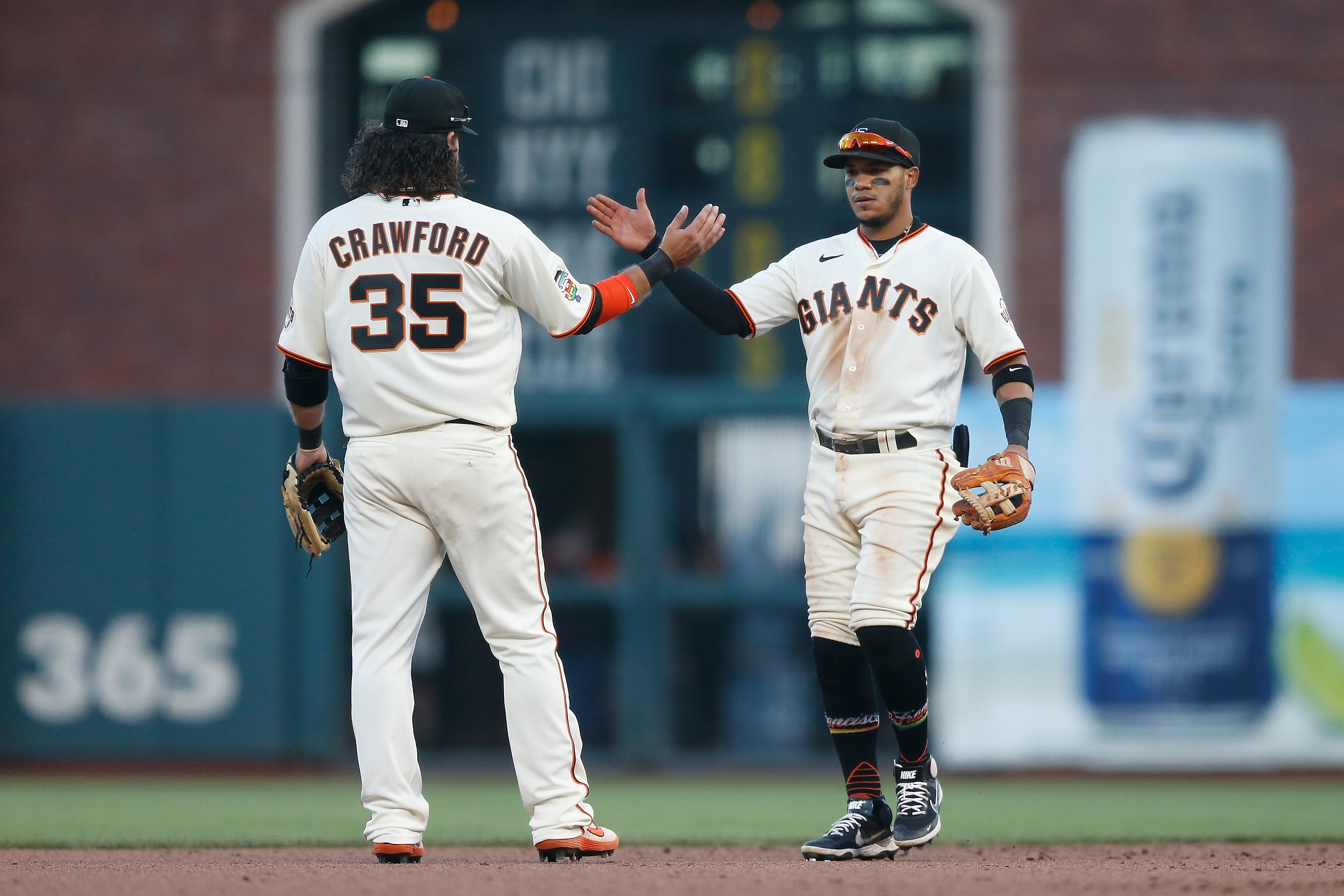 A photo of Thairo Estrada and Brandon Crawford high-fiving after the Giants beat the Dodgers 3-2 on Saturday night.