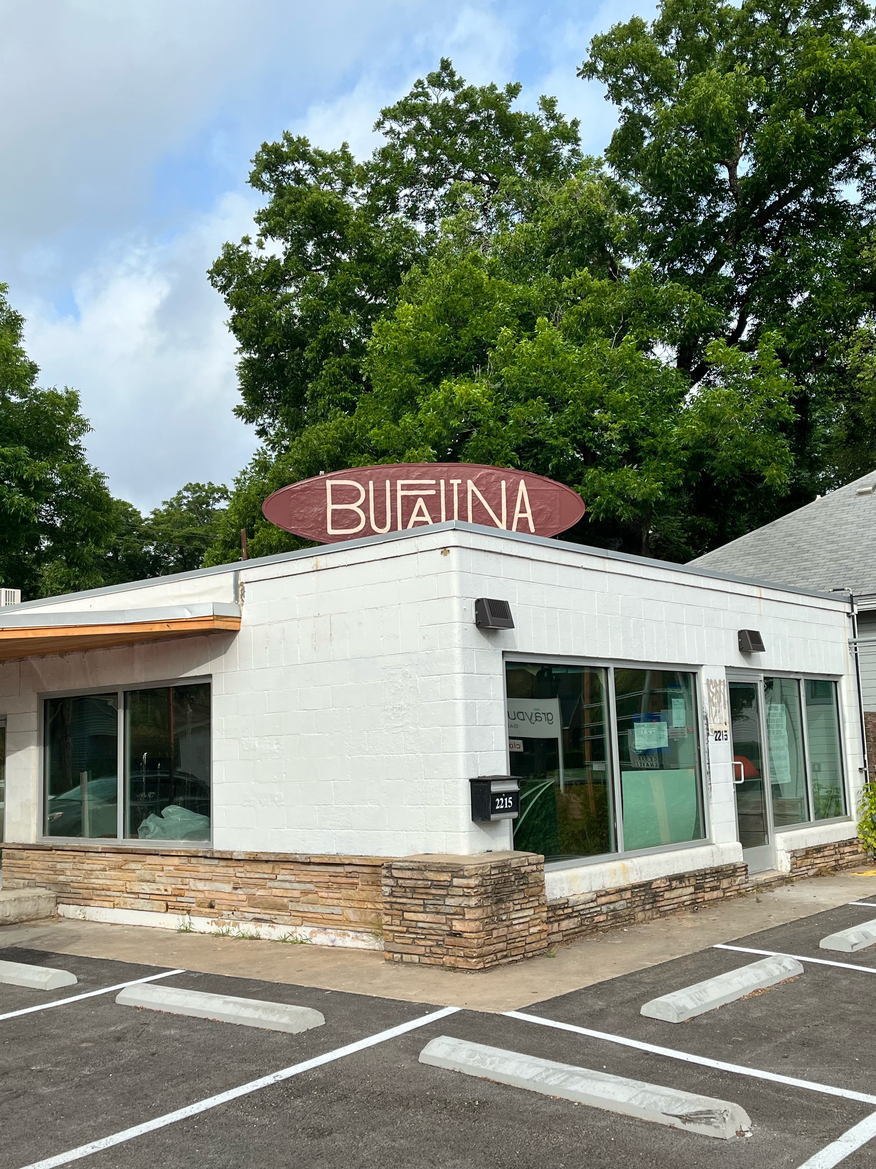 A building seen from the corner with a sign reading “Bufalina.”