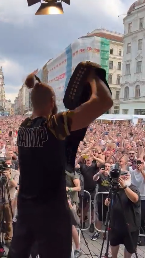 Jiri Prochazka holds his UFC title belt up for the cheering crowd in Brno, Czechia.