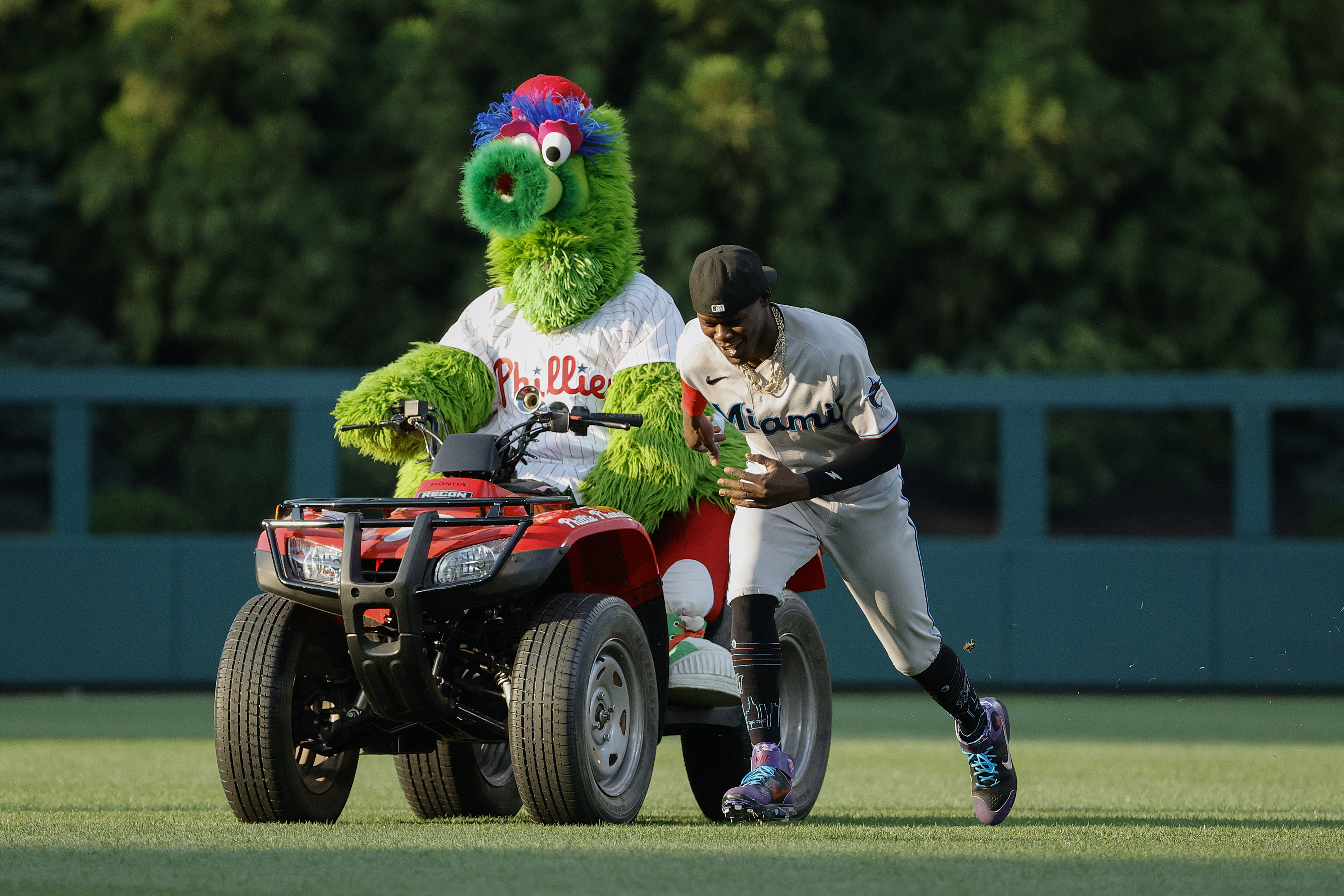 Jazz Chisholm Jr. #2 of the Miami Marlins warms up with the Phillie Phanatic before a game between the Miami Marlins and the Philadelphia Phillies at Citizens Bank Park on June 13, 2022 in Philadelphia, Pennsylvania.