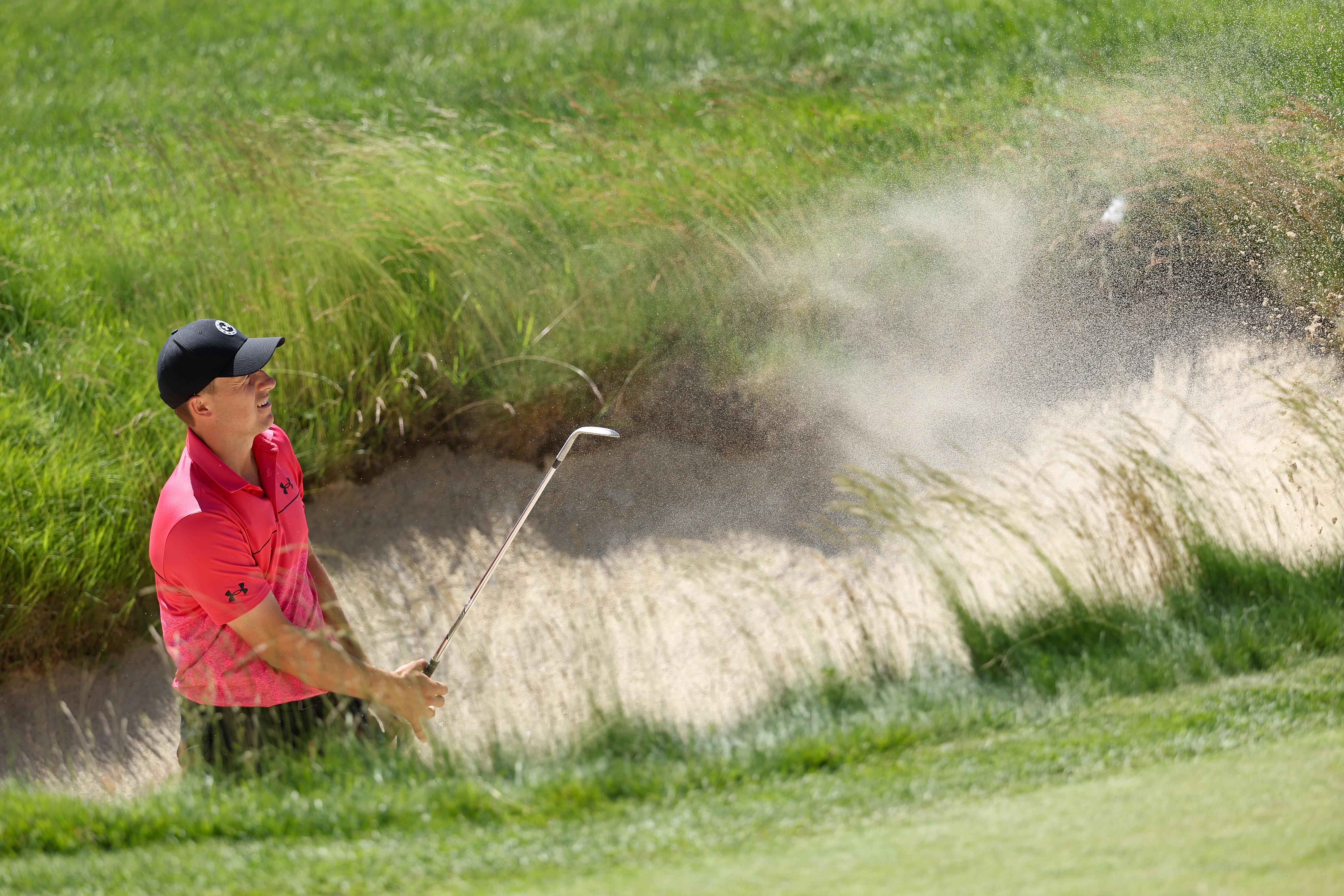 Jordan Spieth of the United States plays from a bunker during a practice round prior to the US Open at The Country Club on June 14, 2022 in Brookline, Massachusetts.
