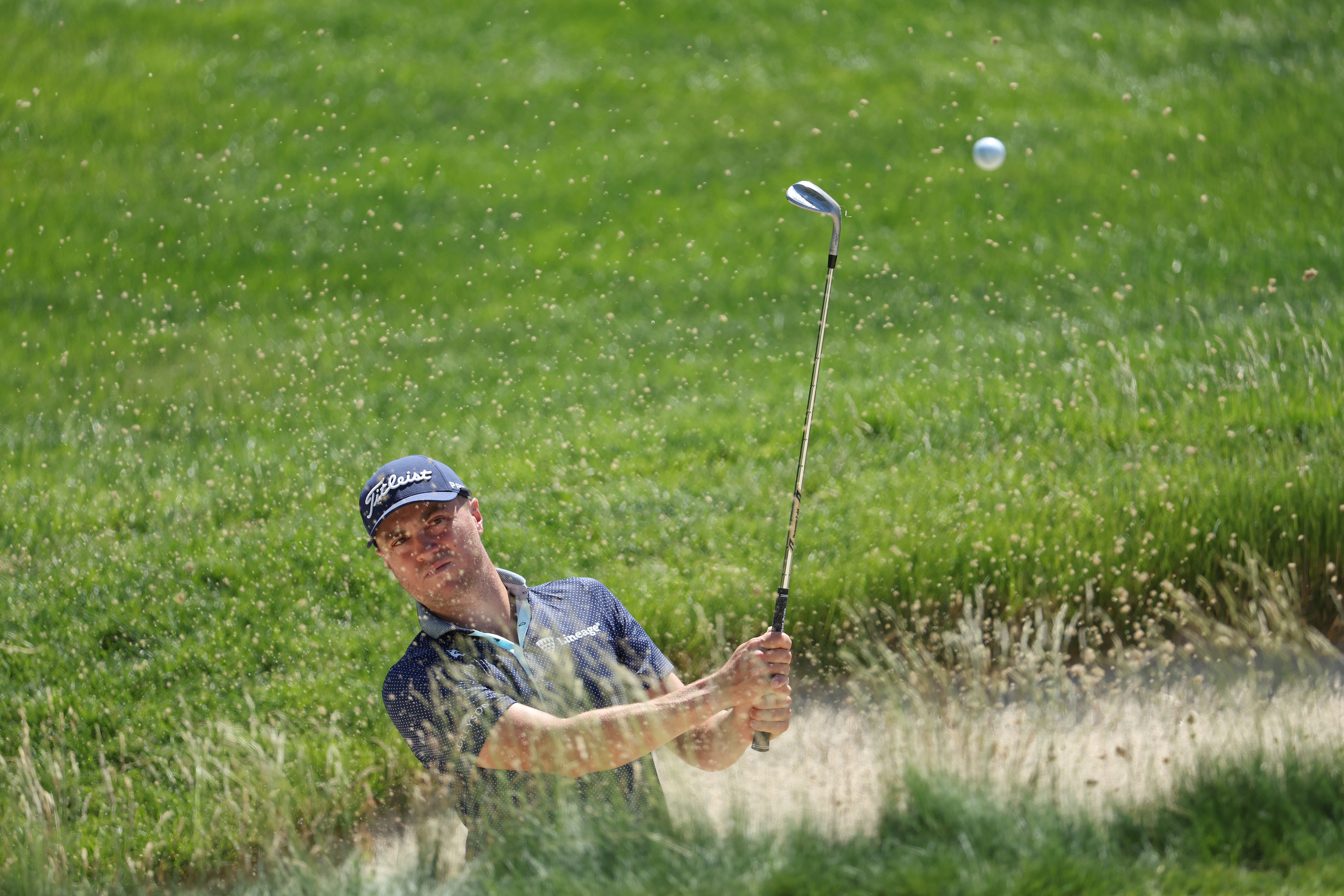 Justin Thomas of the United States plays a shot from a bunker on the fifth hole during a practice round prior to the US Open at The Country Club on June 14, 2022 in Brookline, Massachusetts.