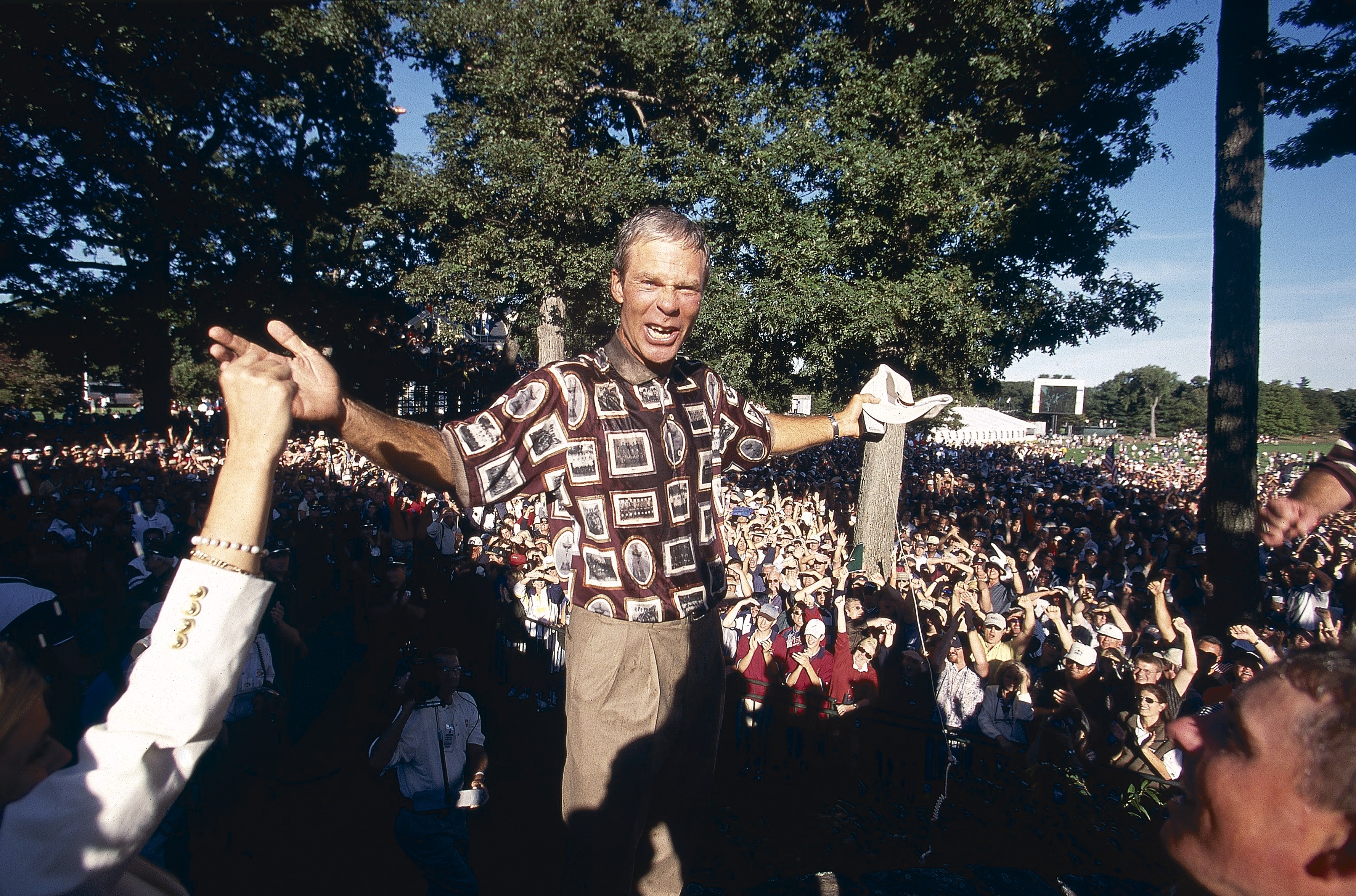 Ryder Cup, USA Ben Crenshaw showing off team attire for tournament with fans at The Country Club, Brookline, MA 9/26/1999