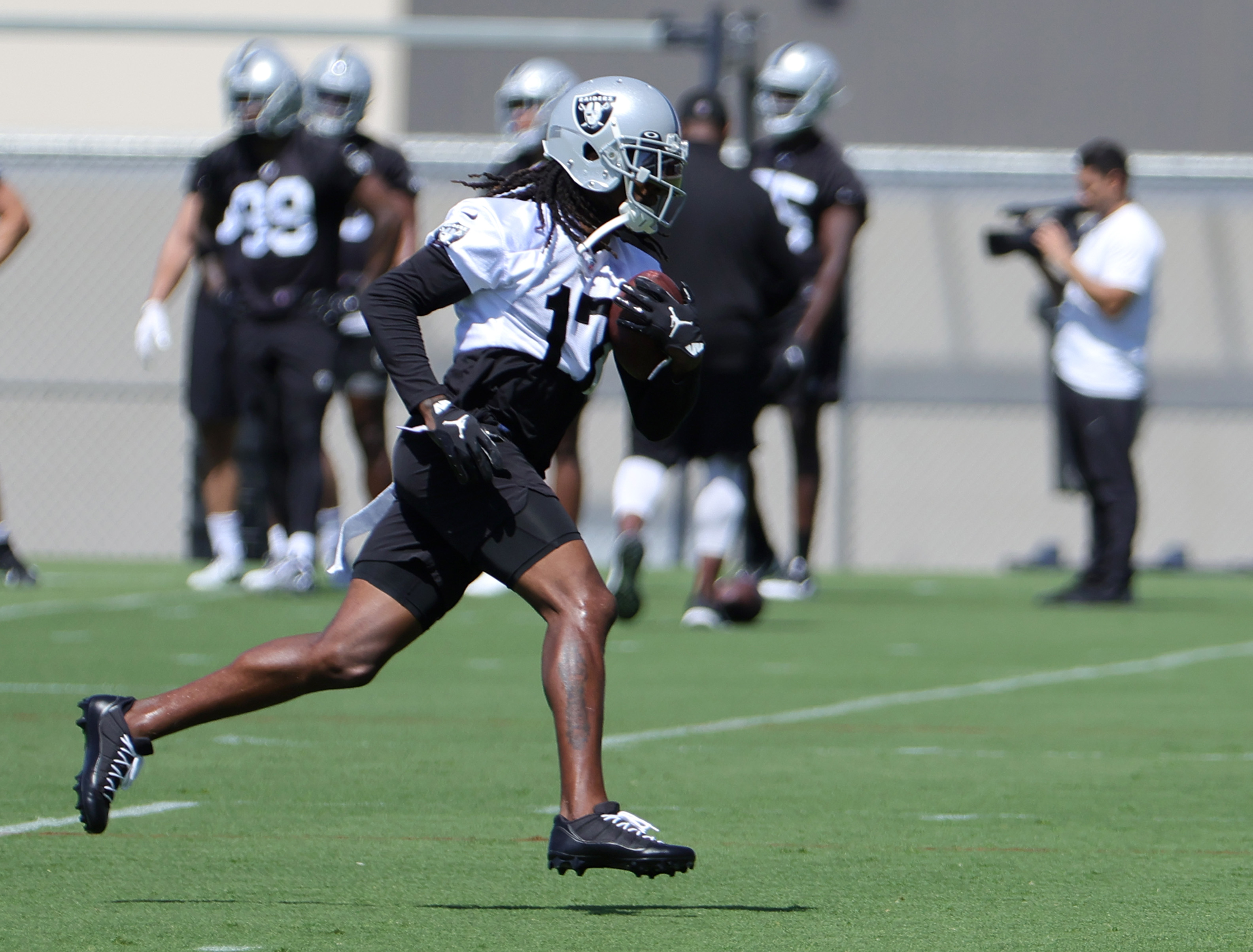 Wide receiver Davante Adams #17 of the Las Vegas Raiders runs with the ball during mandatory minicamp at the Las Vegas Raiders Headquarters/Intermountain Healthcare Performance Center on June 07, 2022 in Henderson, Nevada.