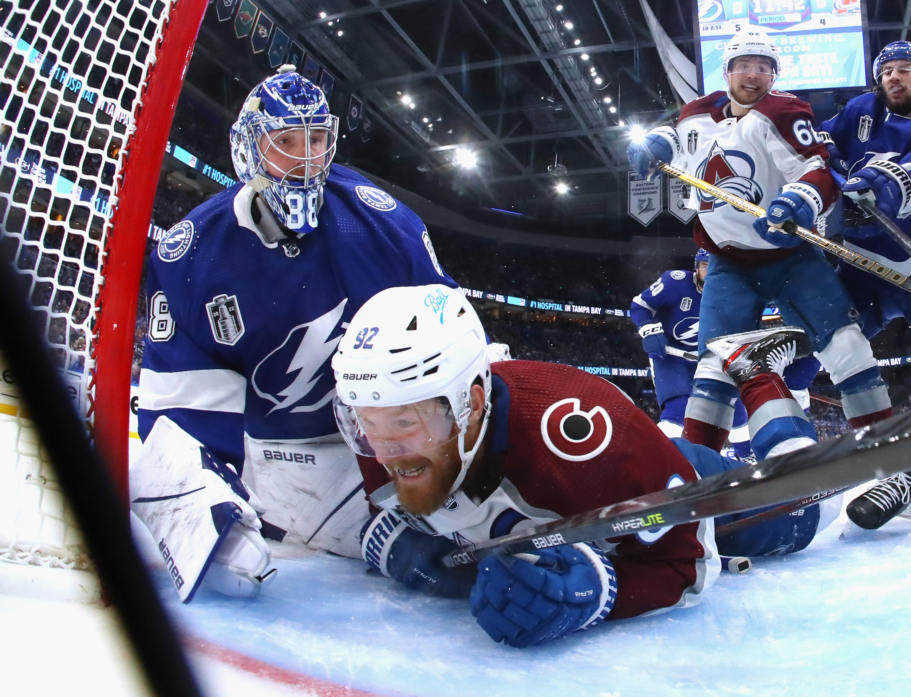 Gabriel Landeskog #92 of the Colorado Avalanche gets tangled up with Andrei Vasilevskiy #88 of the Tampa Bay Lightning during Game 3 of the 2022 NHL Stanley Cup Final at Amalie Arena on June 20, 2022 in Tampa, Florida.