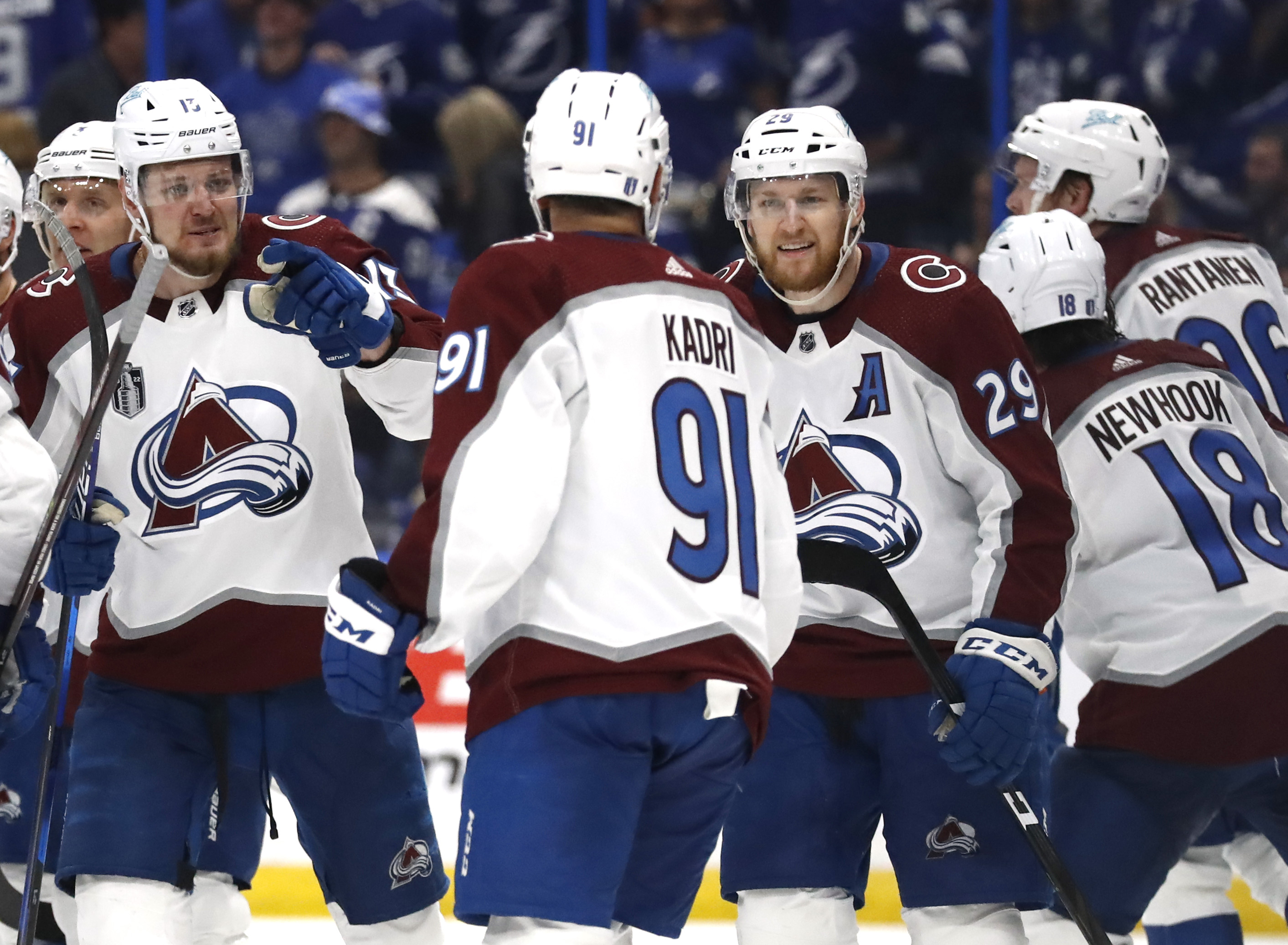 Valeri Nichushkin #13 and Nathan MacKinnon #29 of the Colorado Avalanche celebrate the game winning goal by Nazem Kadri #91 who scored in overtime to defeat the Tampa Bay Lightning 3-2 in Game Four of the 2022 NHL Stanley Cup Final at Amalie Arena on June 22, 2022 in Tampa, Florida.
