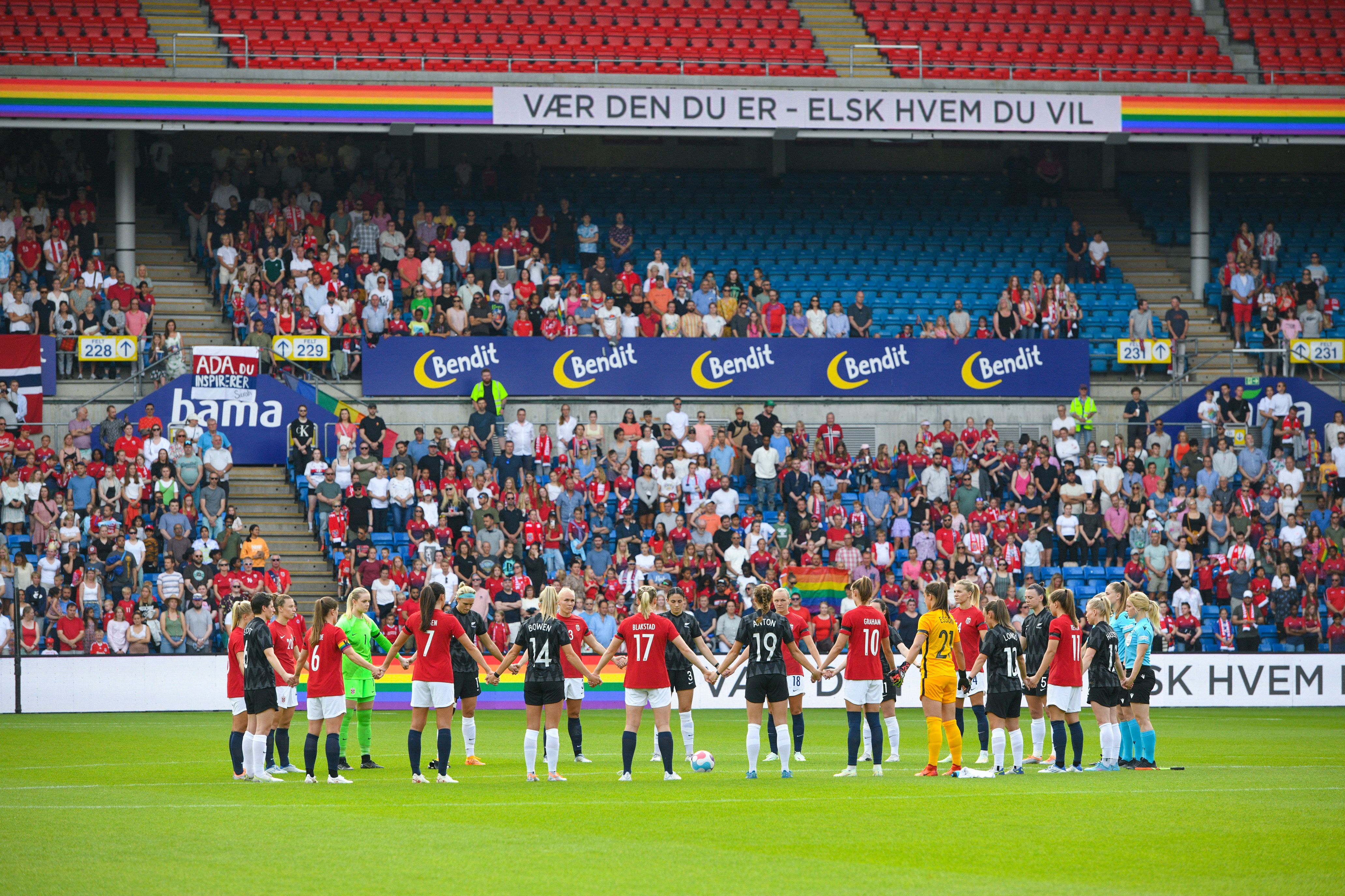 Players from Norway and New Zealand observe a minute of silence Saturday in Oslo for the victims of the shooting at a gay bar.