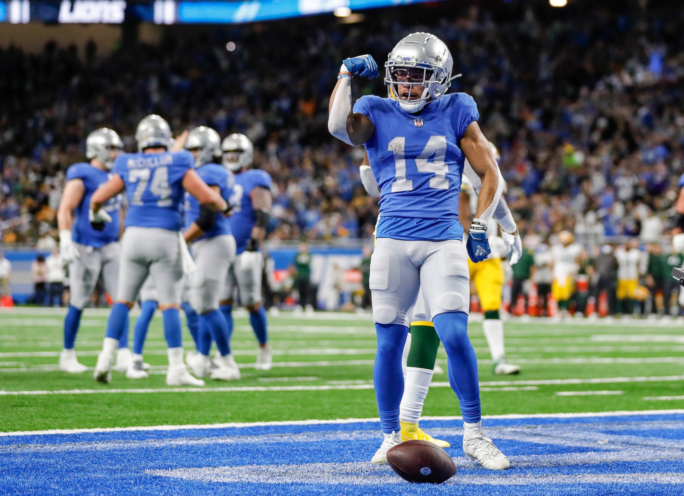 Lions wide receiver Amon-Ra St. Brown scores a touchdown during the first half of the Lions’ 37-30 win over the Packers on Sunday, Jan. 9, 2022, at Ford Field.