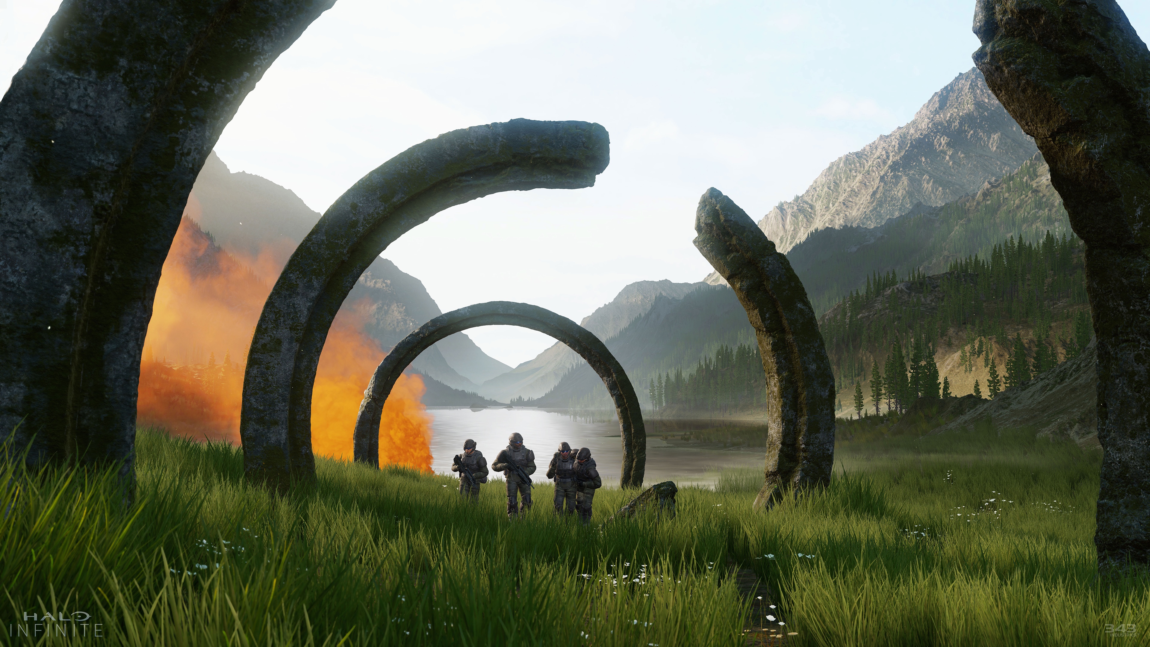 Ancient rings encircle four marines on a grassy plain in a screenshot for Halo Infinite