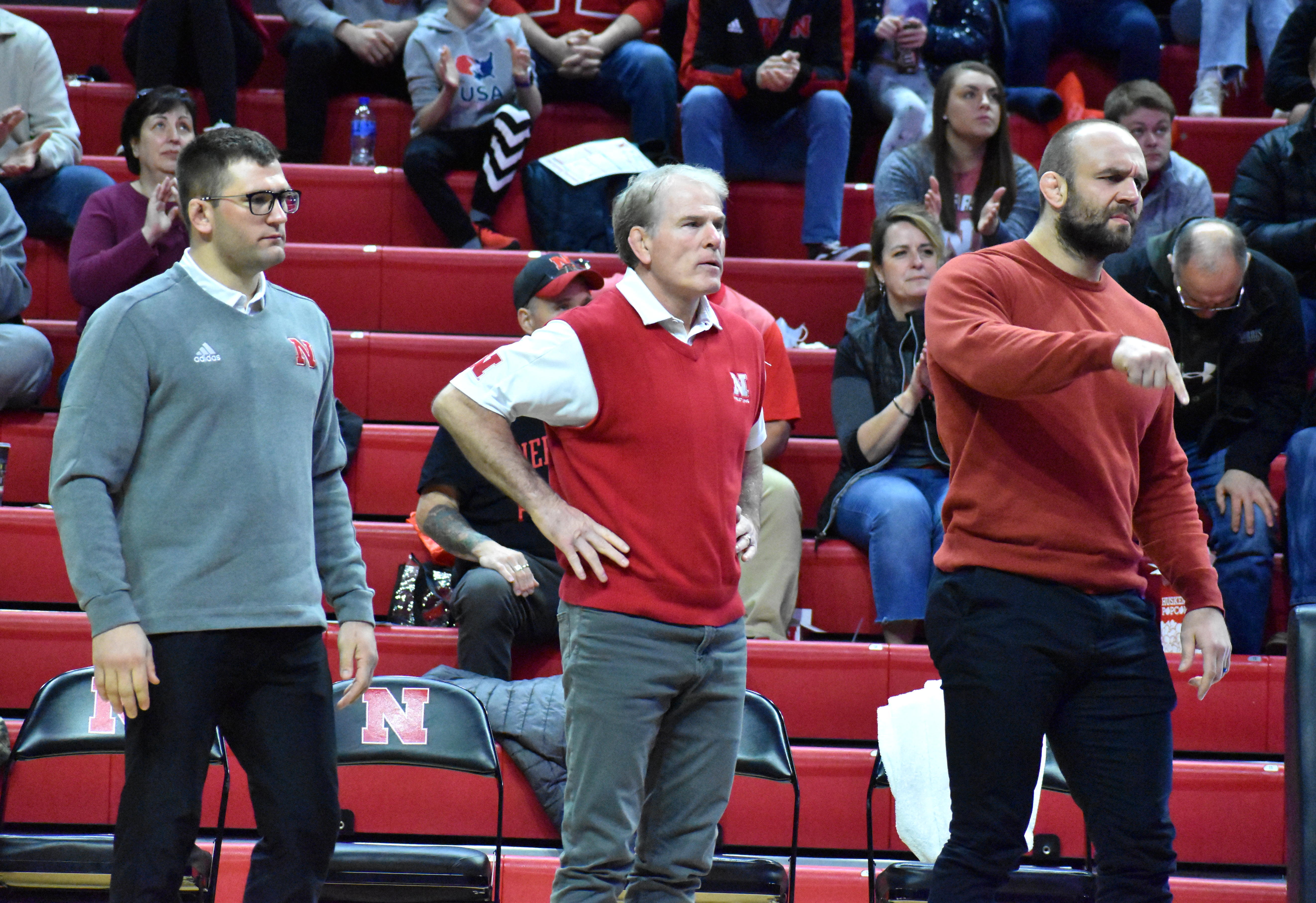 Nebraska Head Coach Mark Manning (middle), volunteer assistant Tervel Dlagnev (right), and assistant coach Robert Kokesh (left) look on during a dual against Illinois on Feb. 13, 2022 at the Bob Devaney Sports Center.