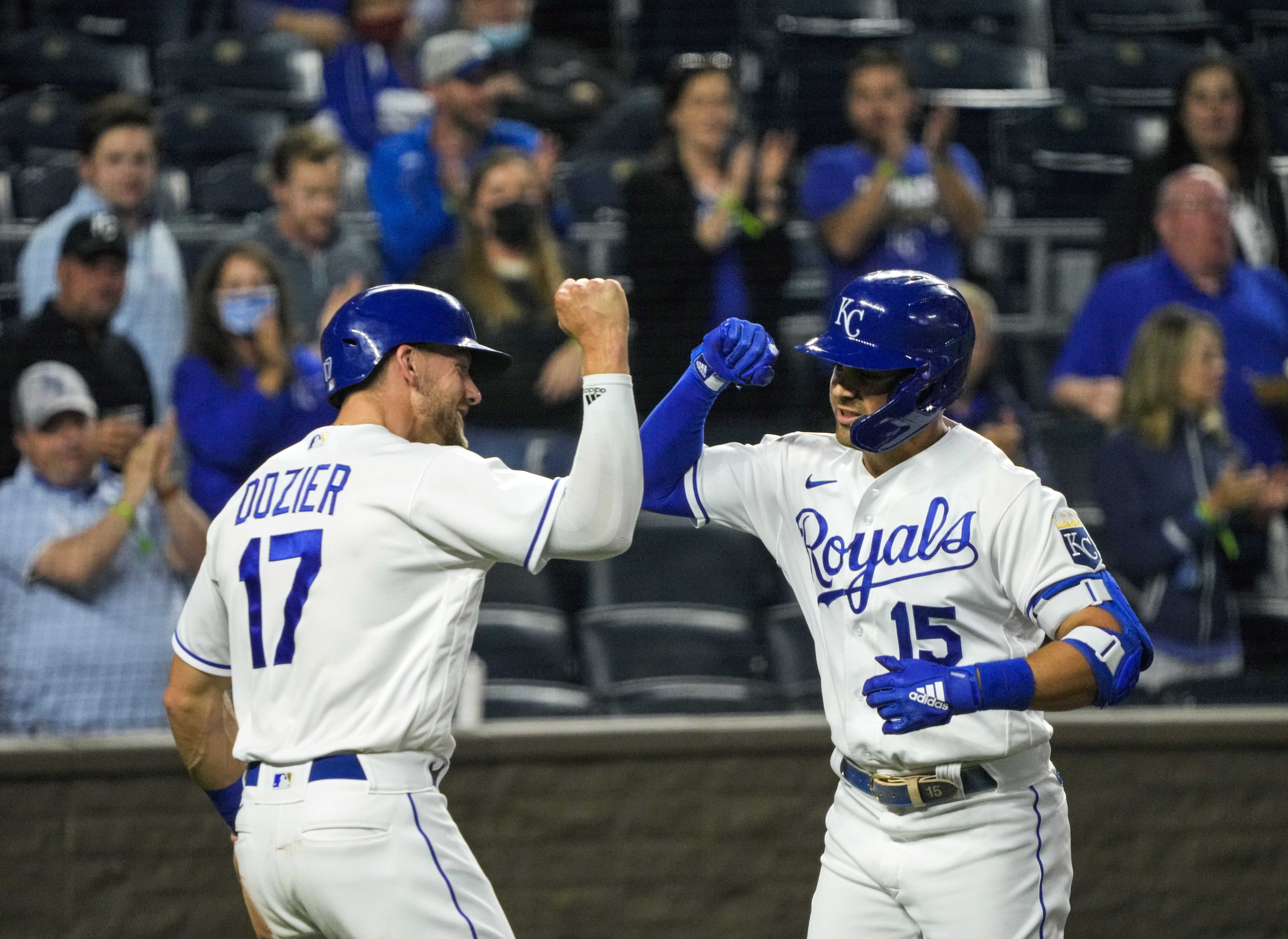 Kansas City Royals second baseman Whit Merrifield (15) is congratulated by third baseman Hunter Dozier (17) after hitting a home run against the Cleveland Indians during the fourth inning at Kauffman Stadium.