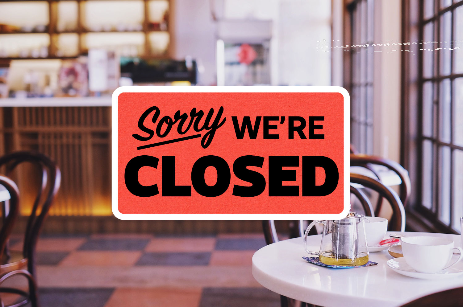 A casual cafe with a red sign overlaying the image that reads “Sorry We’re Closed”