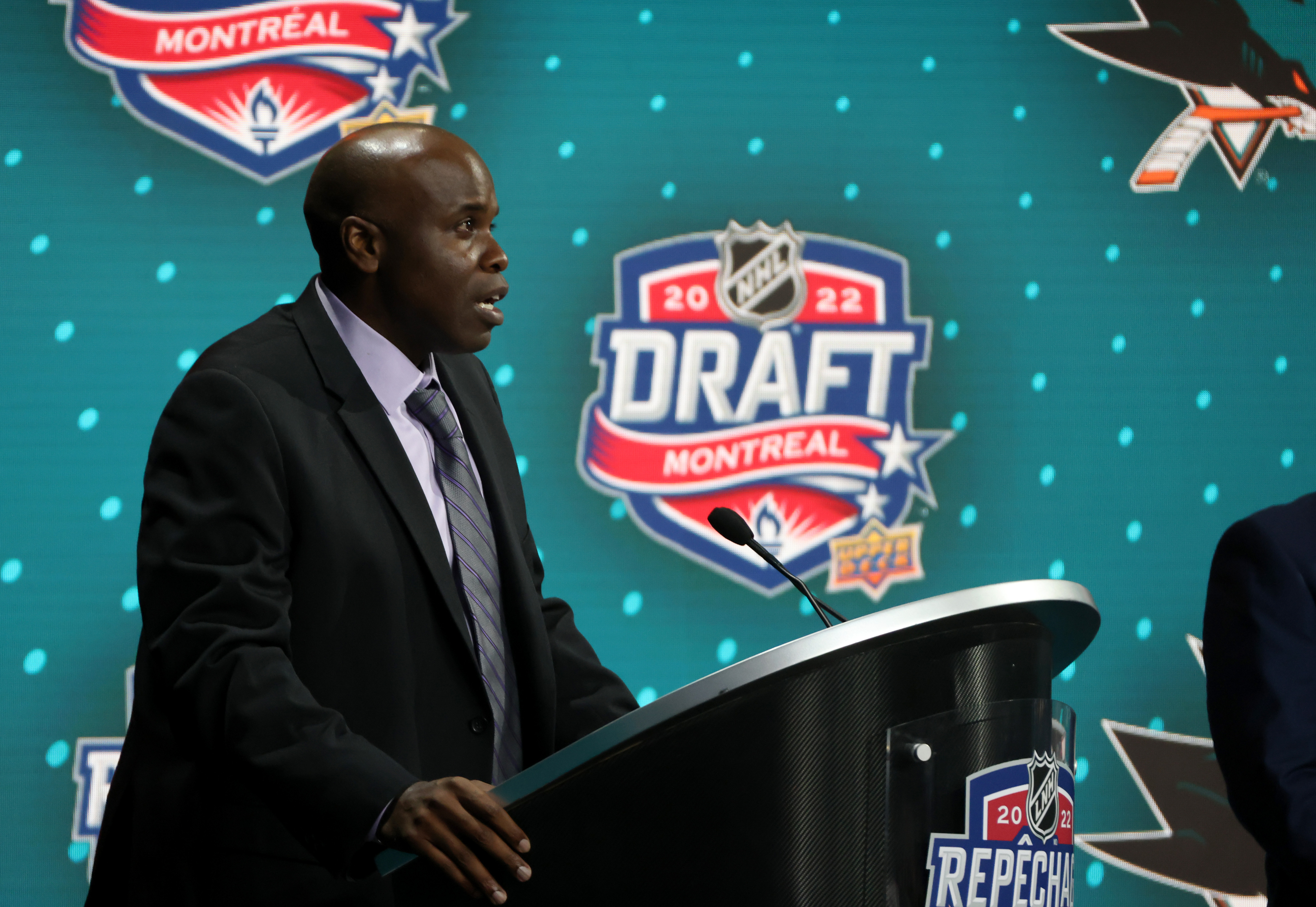 General manager Mike Grier of the San Jose Sharks speaks at the podium during the first round of the 2022 Upper Deck NHL Draft at Bell Centre on July 07, 2022 in Montreal, Quebec.
