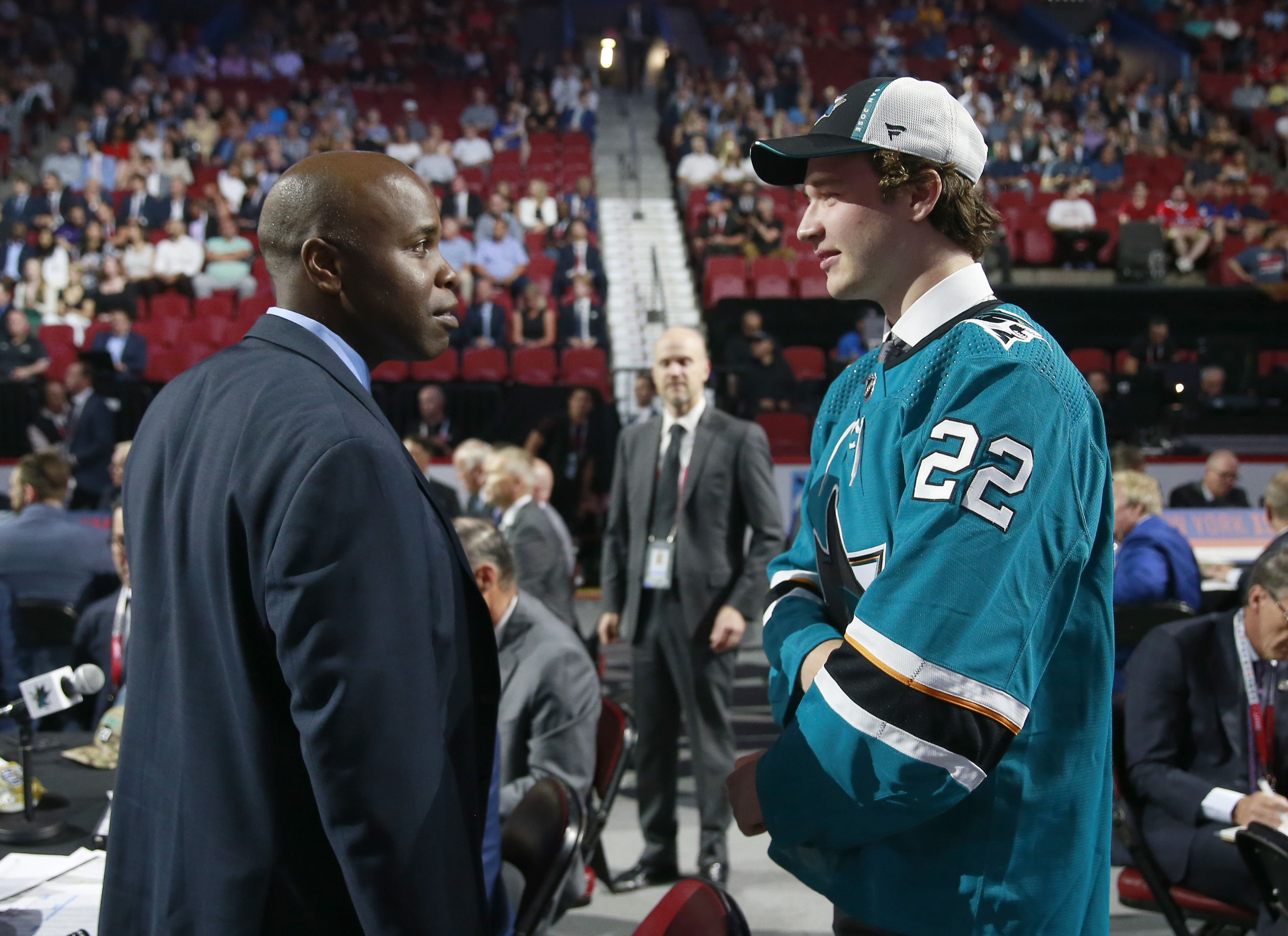 Cameron Lund talks with general manager Mike Grier of the San Jose Sharks (L) after being selected 34th overall by the San Jose Sharks during the 2022 Upper Deck NHL Draft at Bell Centre on July 08, 2022 in Montreal, Quebec.