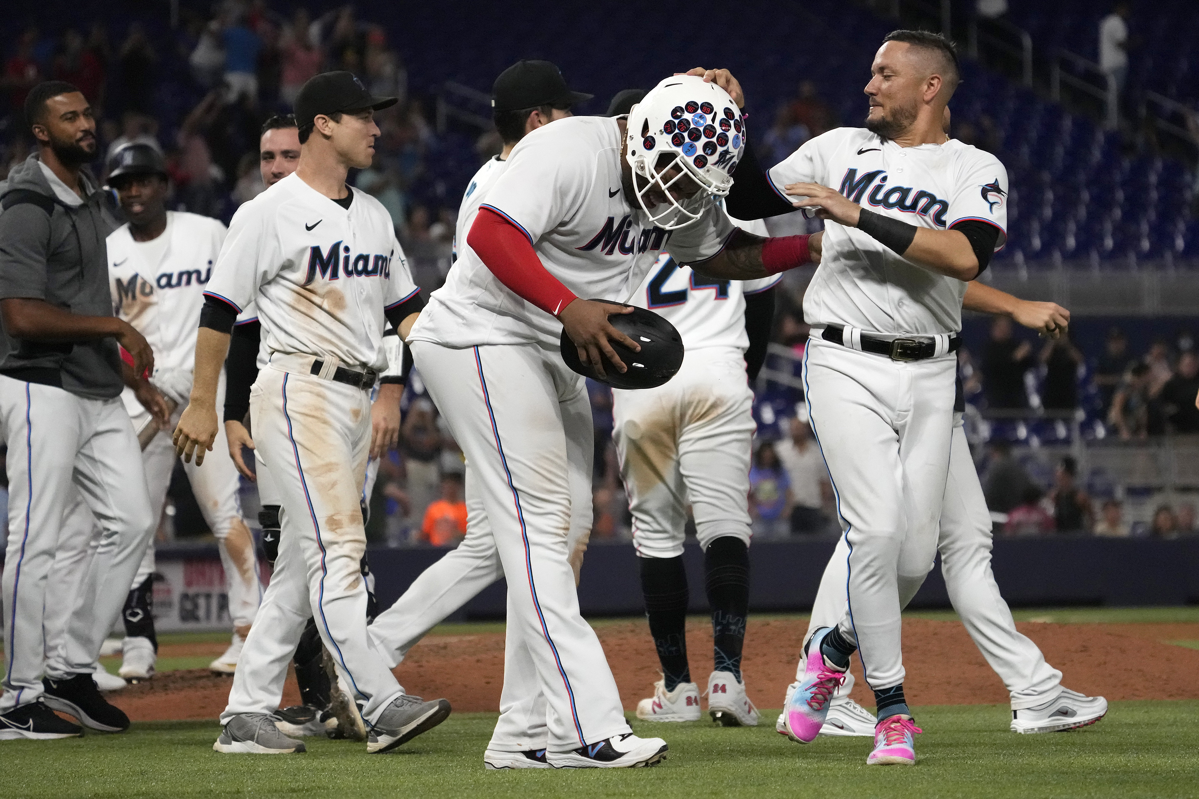 Miami Marlins teammates celebrate defeating the Pittsburgh Pirates after Miami Marlins first baseman Jesus Aguilar (99) scored the walk off game winning run on a wild pitch by Pittsburgh Pirates relief pitcher David Bednar (not pictured) at loanDepot park.