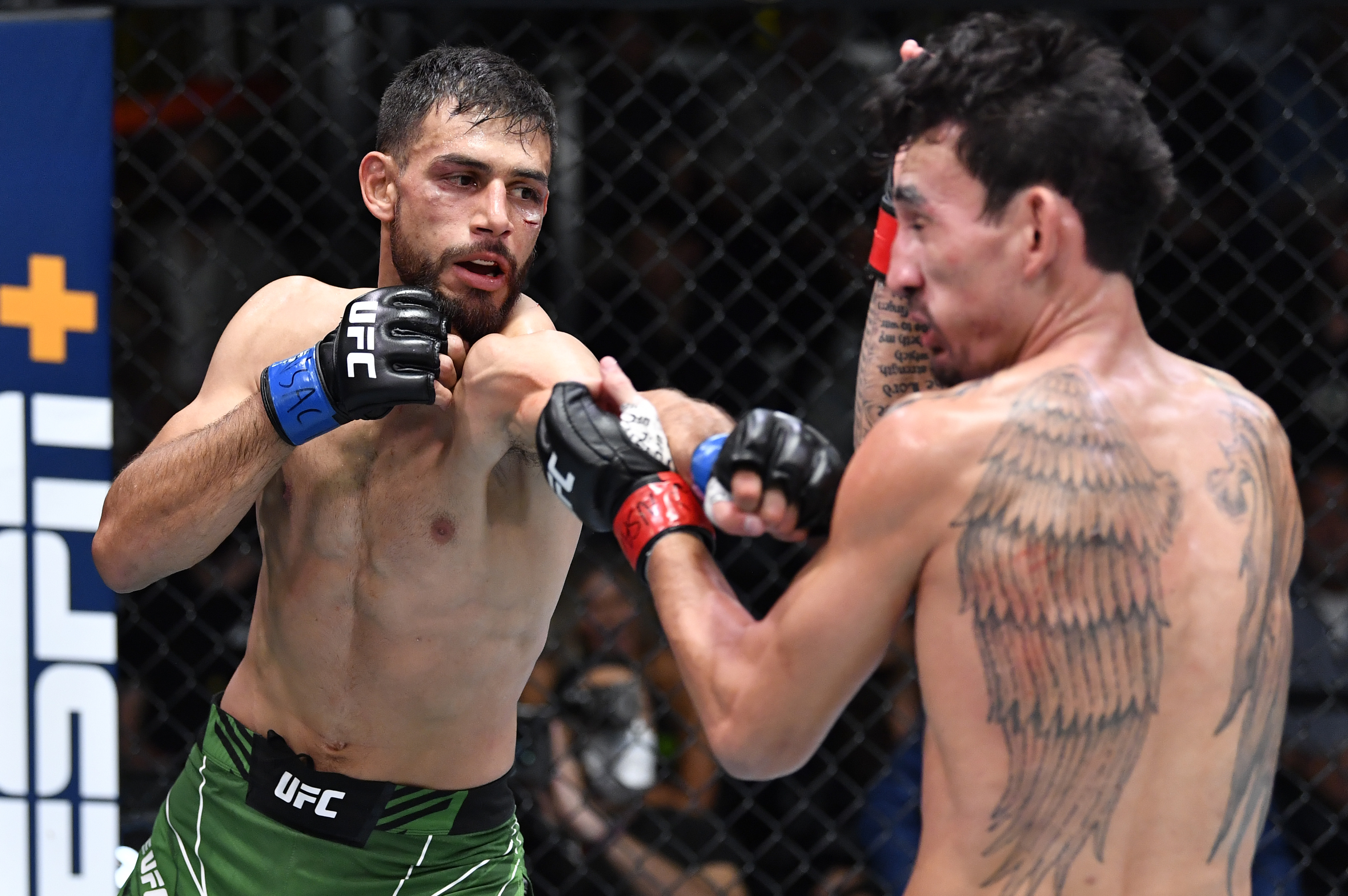 Yair Rodriguez of Mexico punches Max Holloway in a featherweight fight during the UFC Fight Night event at UFC APEX on November 13, 2021 in Las Vegas, Nevada.