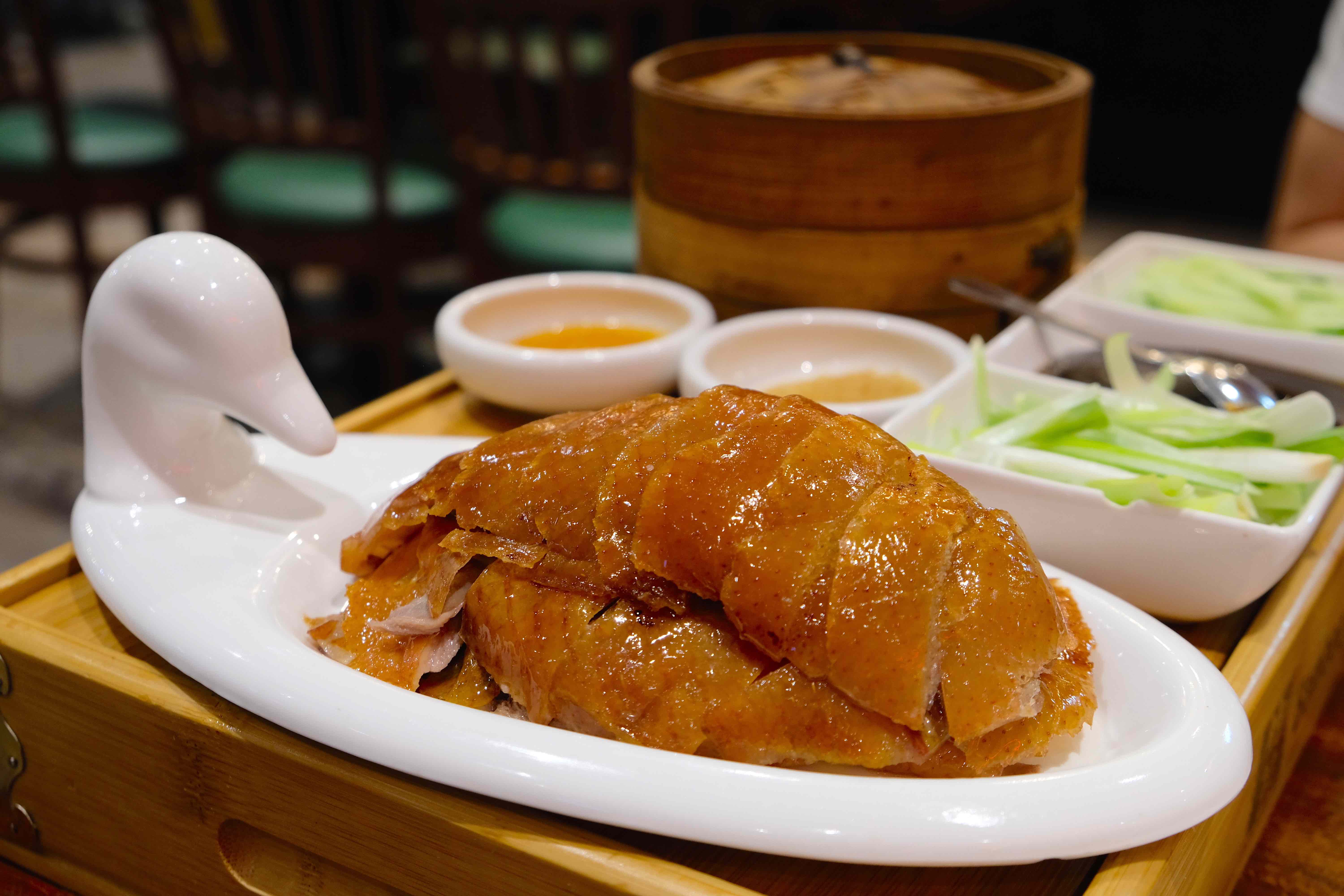 Carved peking duck on a duck-shaped plate.