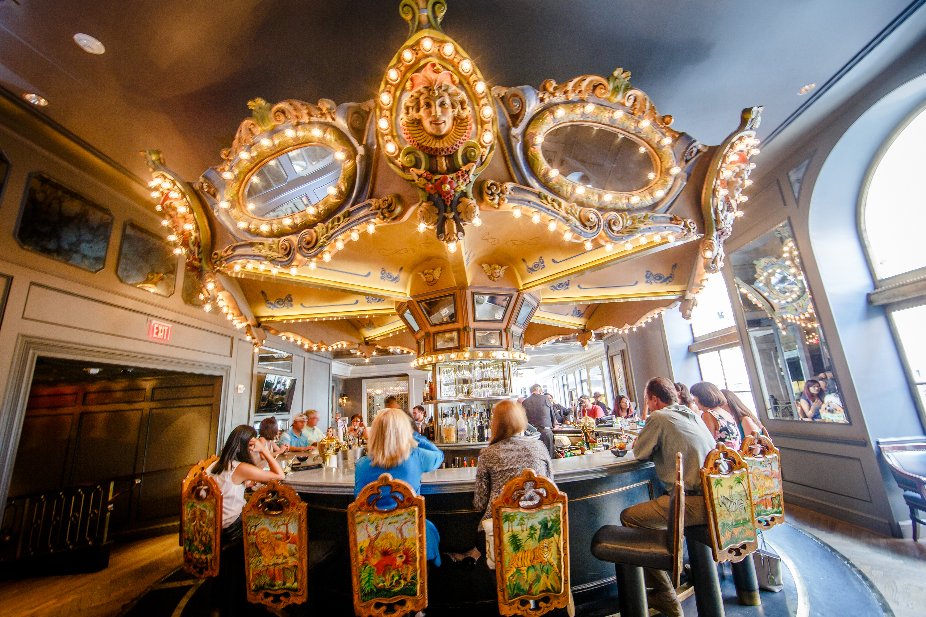 A view of the Carousel Bar, a slowly-rotating bar structure meant to resemble a carousel ride at a carnival, with bulb lights and mirrors. 