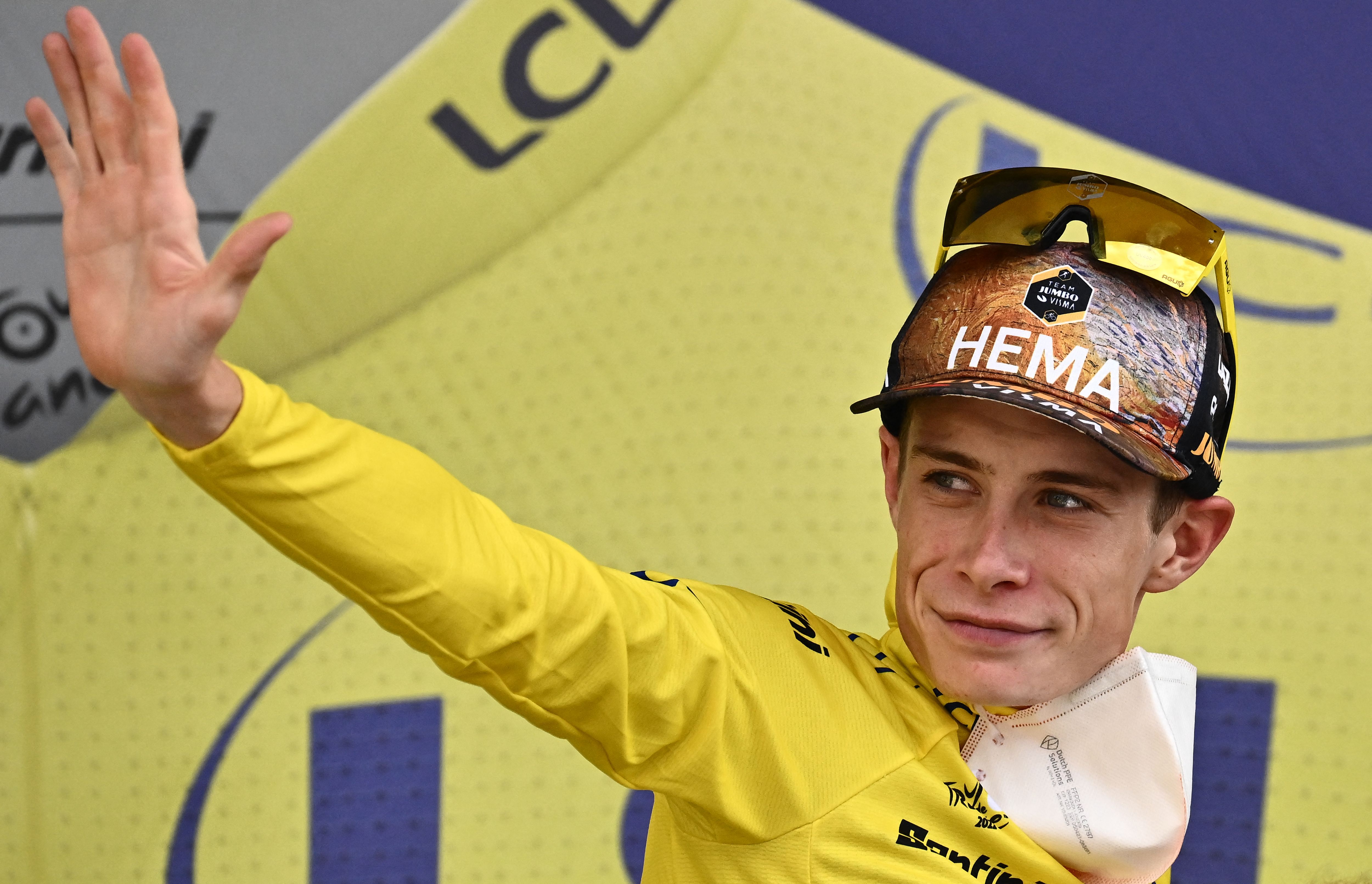 Jumbo-Visma team’s Danish rider Jonas Vingegaard celebrates on the podium with the overall leader’s yellow jersey after the 17th stage of the 109th edition of the Tour de France cycling race, 129,7 km between Saint-Gaudens and Peyragudes, in southwestern France, on July 20, 2022.
