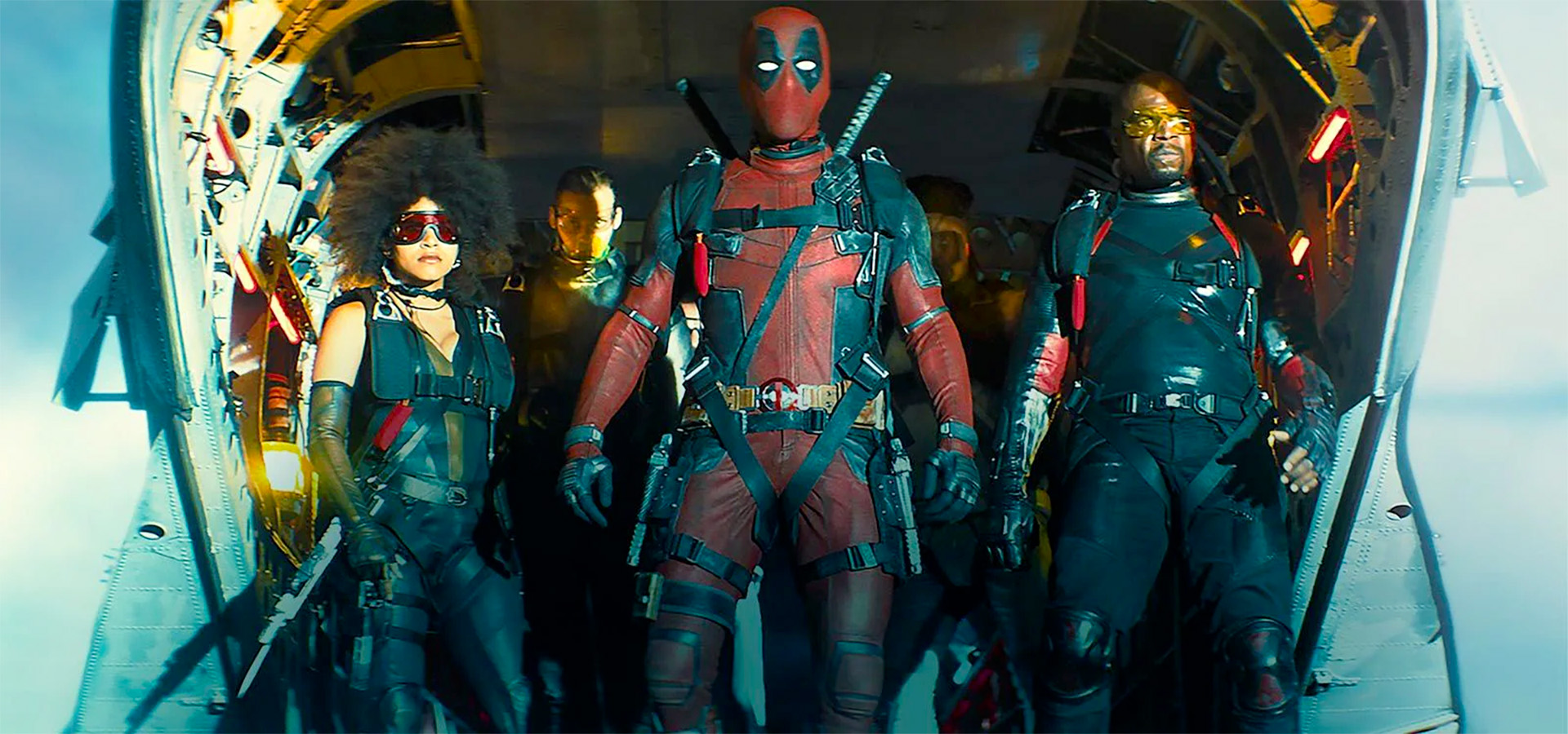 Deadpool and his X-Force team emerge from a transport plane in a still from Deadpool 2