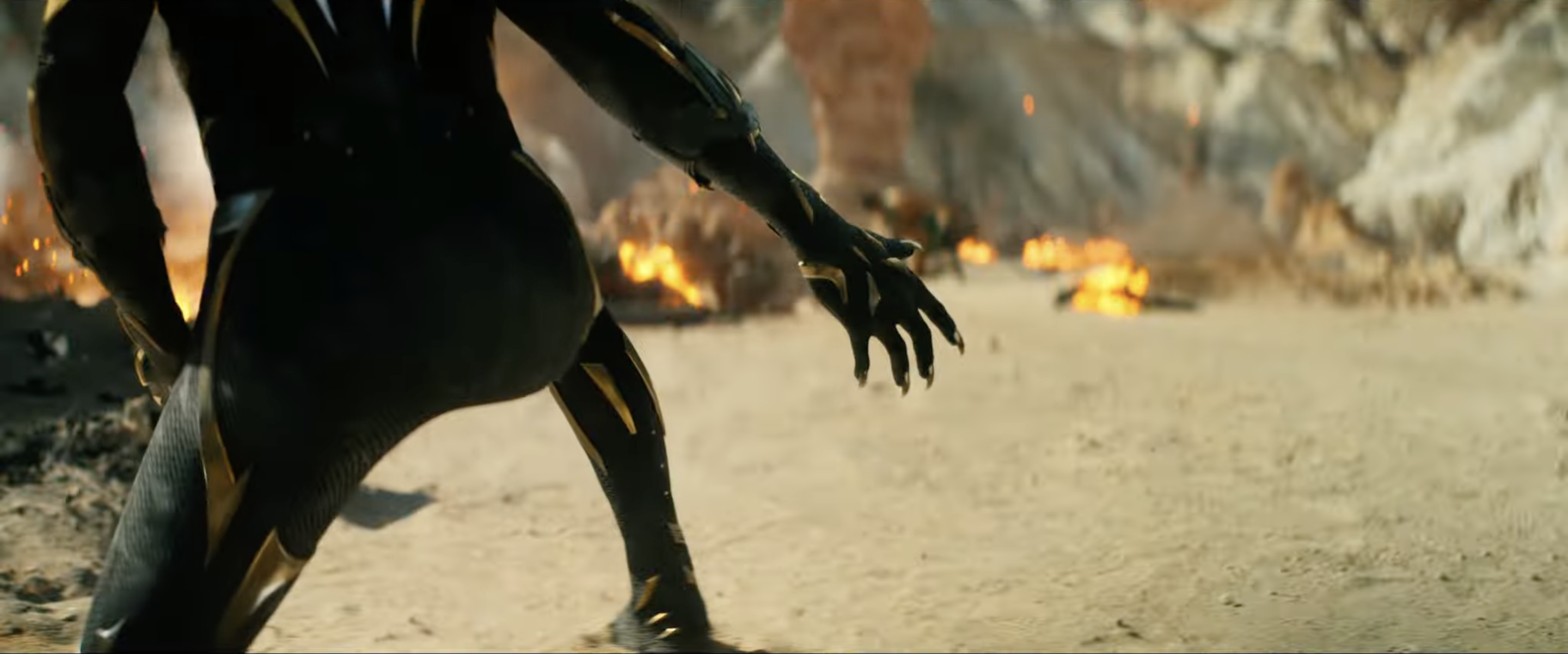 Black Panther crouching in front of an explosion and flexing claws, shot from below, with the head cut off in the image