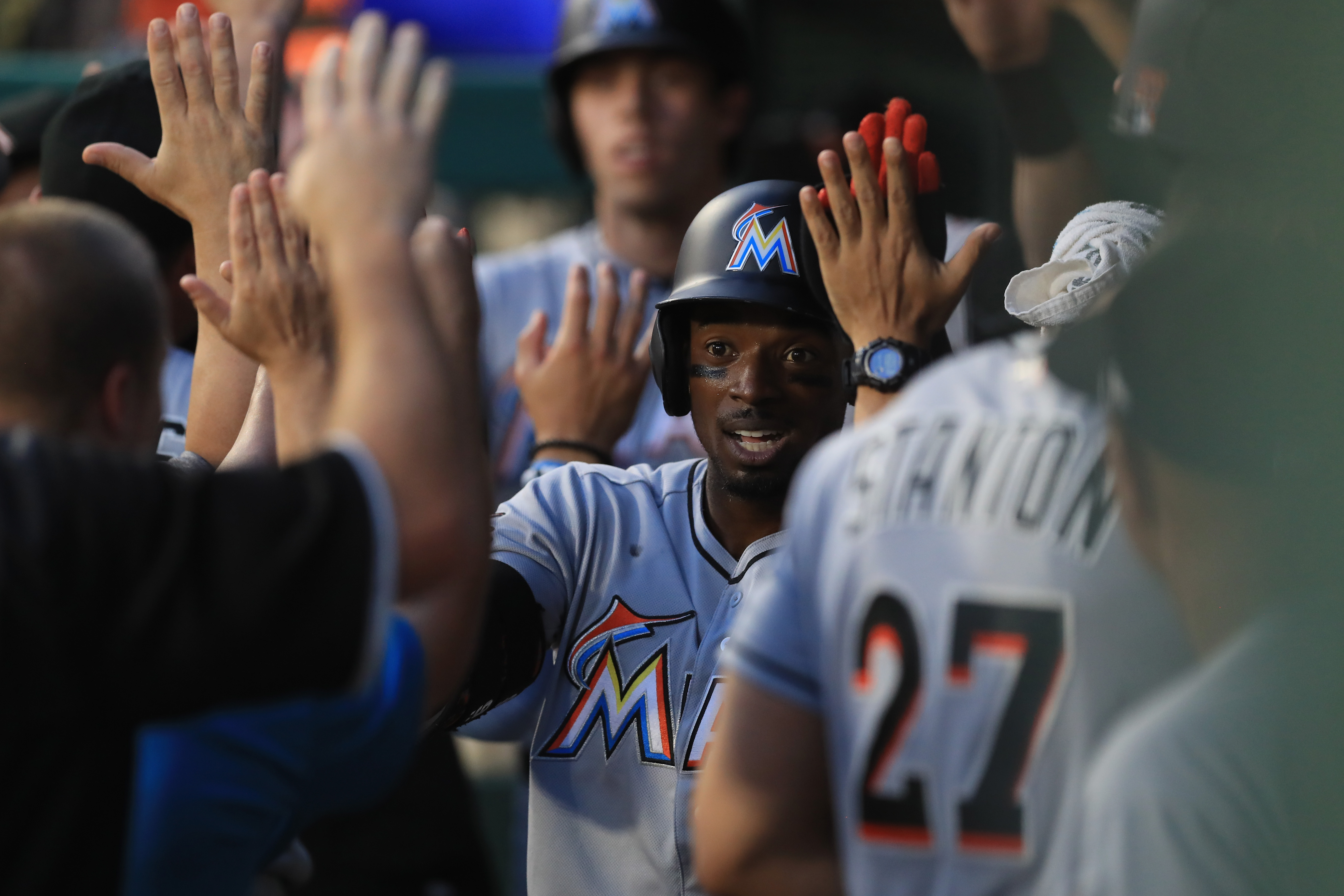 Dee Gordon #9 of the Miami Marlins celebrates after scoring in the fourth inning against the Texas Rangers at Globe Life Park in Arlington on July 26, 2017 in Arlington, Texas.