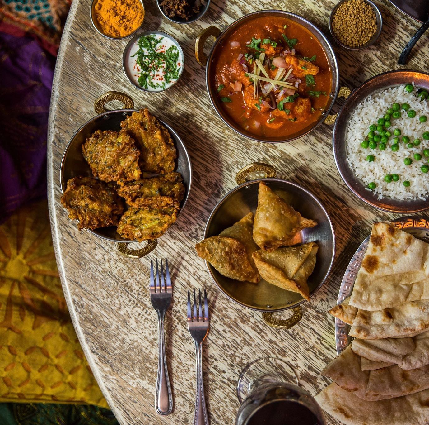 An array of Indian dishes on a table.