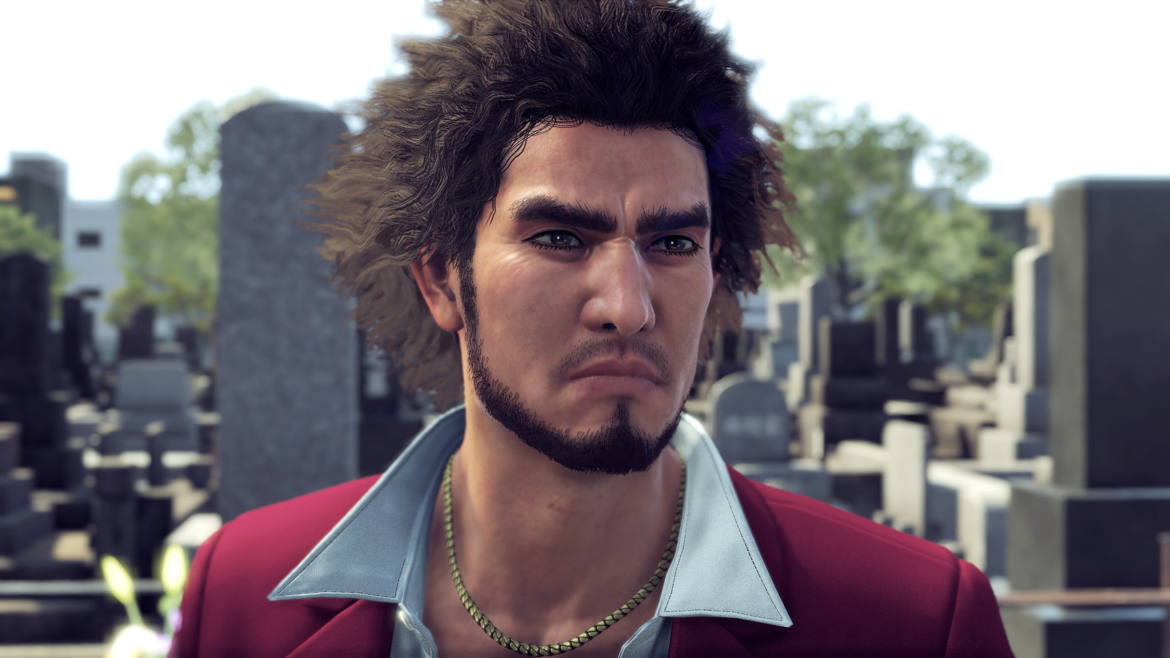 a close-up of Ichiban Kasuga, the protagonist of Yakuza: Like a Dragon, wearing a white dress shirt with a very open collar beneath a burgundy sport coat