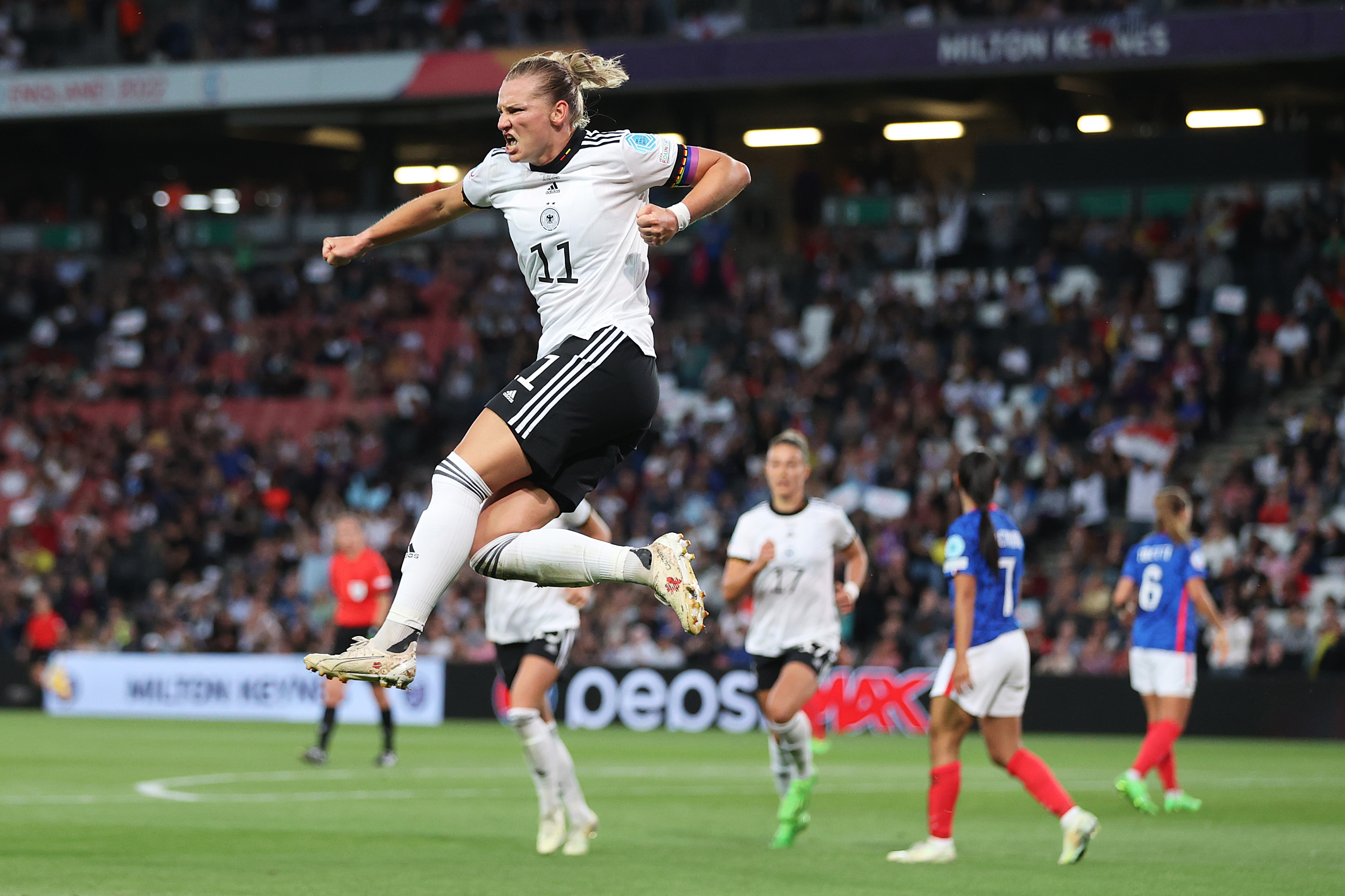 Popp leaps in the air after scoring the opening goal against France