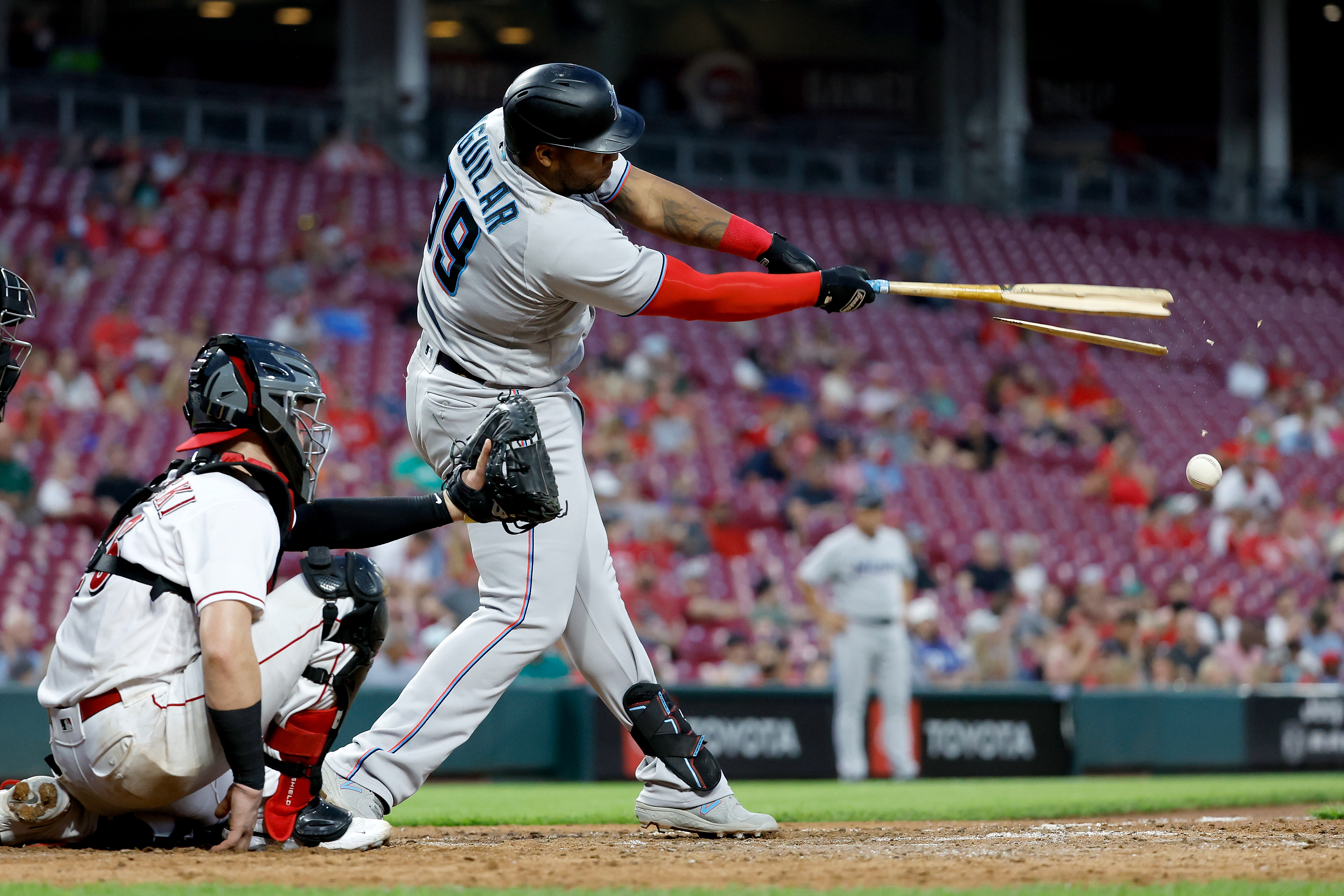Jesus Aguilar #99 of the Miami Marlins breaks his bat while hitting foul ball during the eighth inning of the game against the Cincinnati Reds at Great American Ball Park on July 27, 2022 in Cincinnati, Ohio. Cincinnati defeated Miami 5-3.