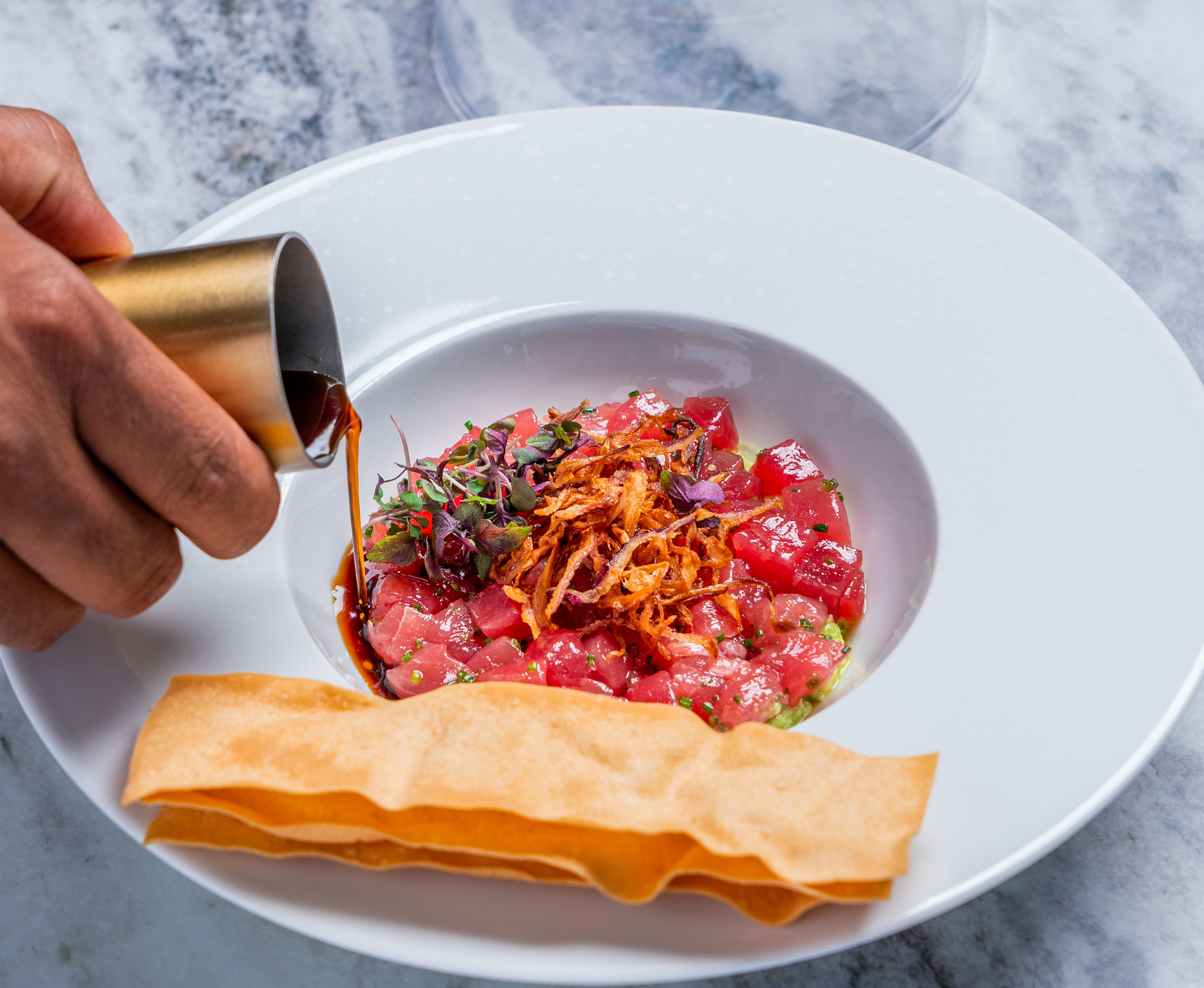 Blue fin tartare at the new Sparrow in Downtown LA’s Hotel Figueroa in a bowl with crackers.