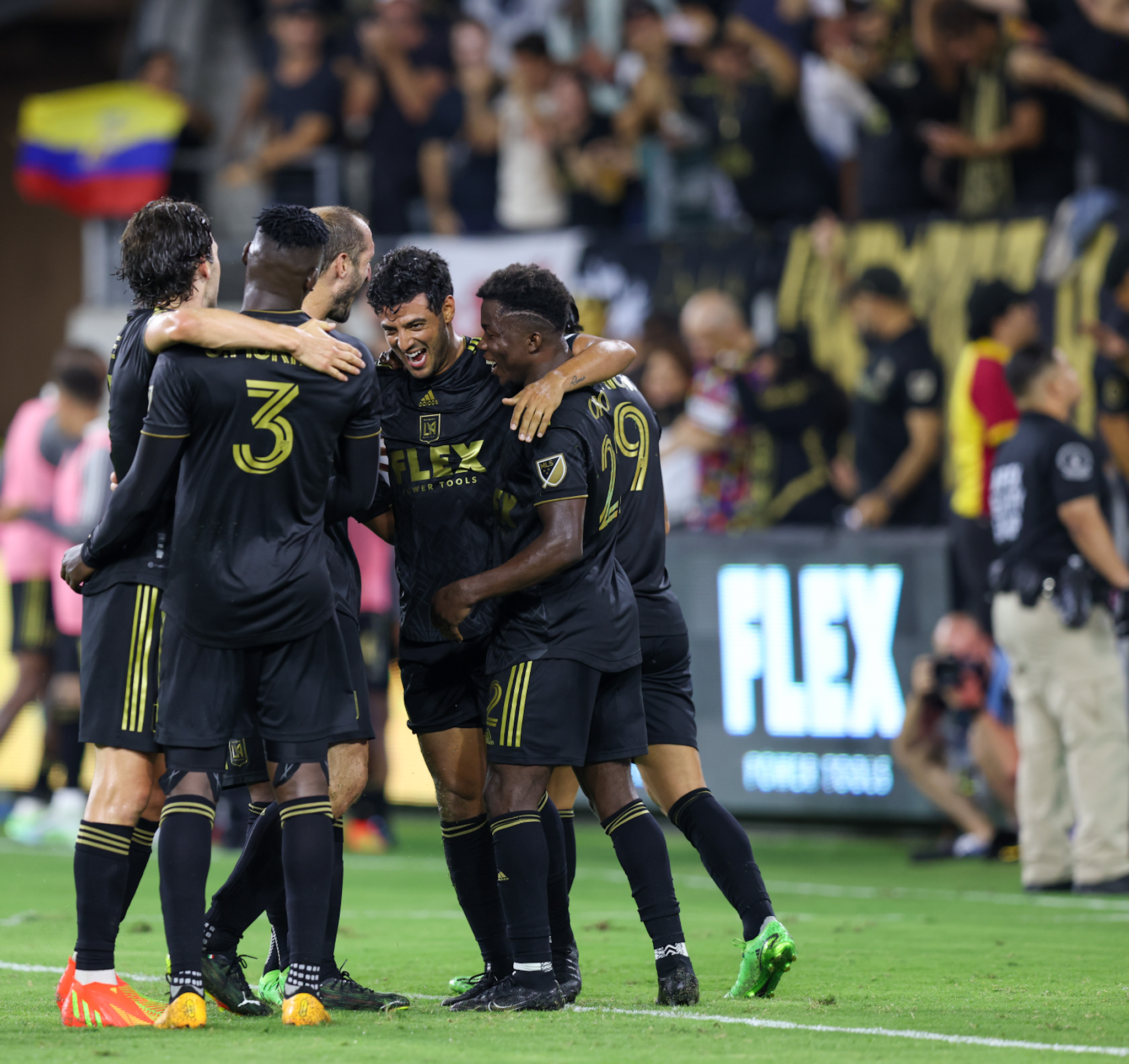 Carlos Vela (center) celebrates with teammates after scoring a goal.