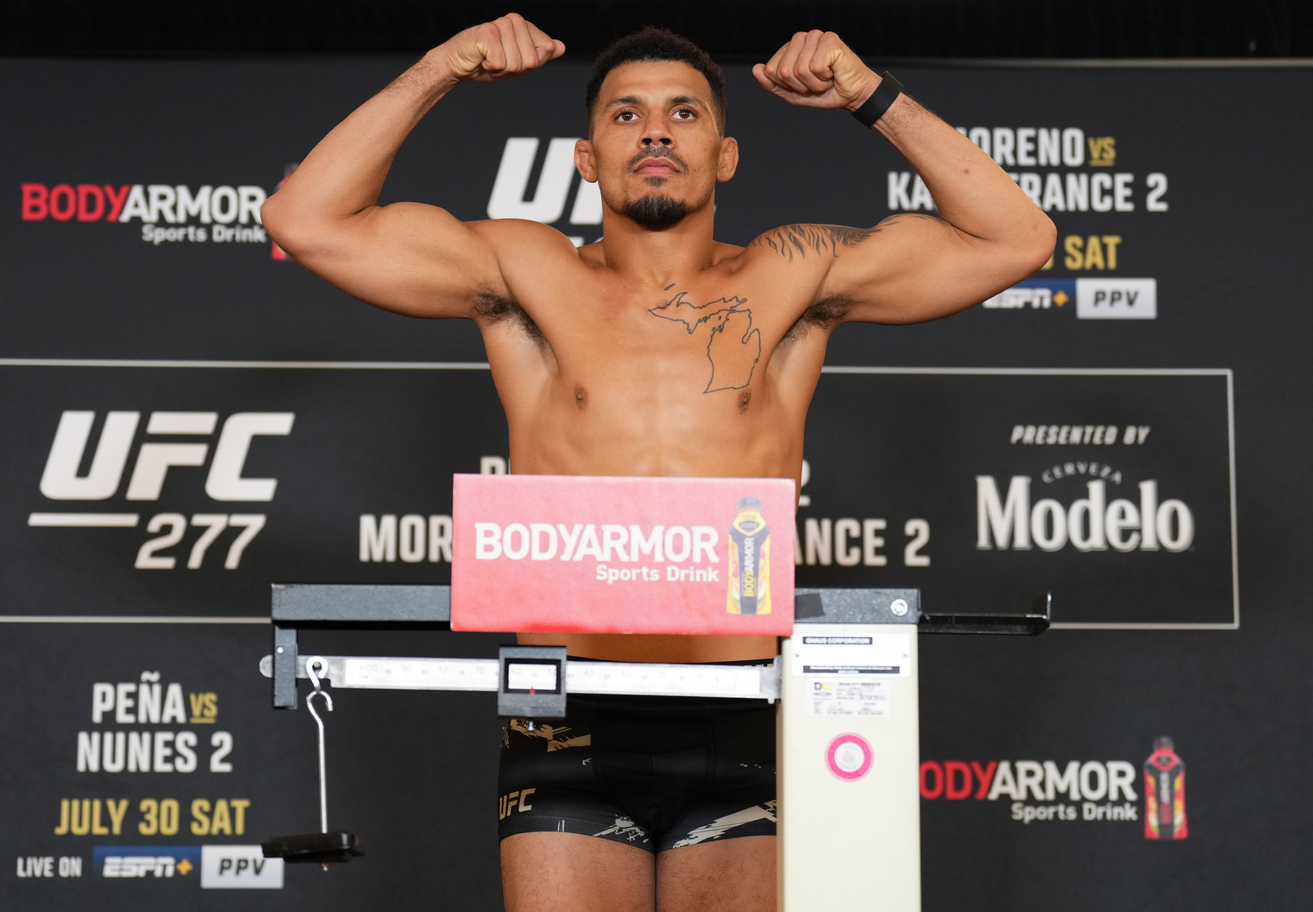 Drakkar Klose poses on the scale during the UFC 277 official weigh-in at the Hyatt Regency hotel