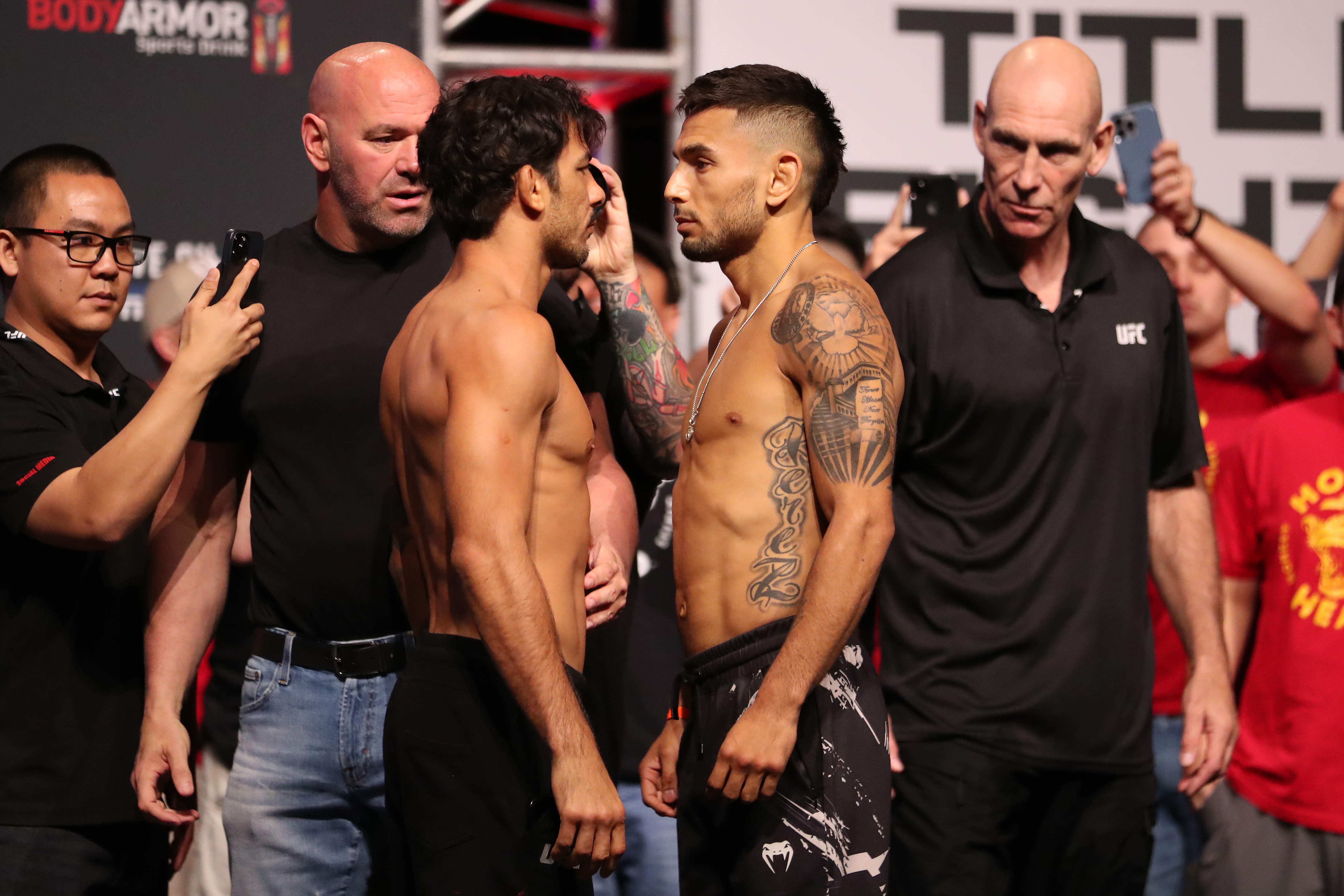 (L-R) Alexandre Pantoia and Alex Perez face-off in front of the fans for the UFC 277 ceremonial weigh-ins on July 29, 2022, at the American Airlines Center in Dallas, TX.