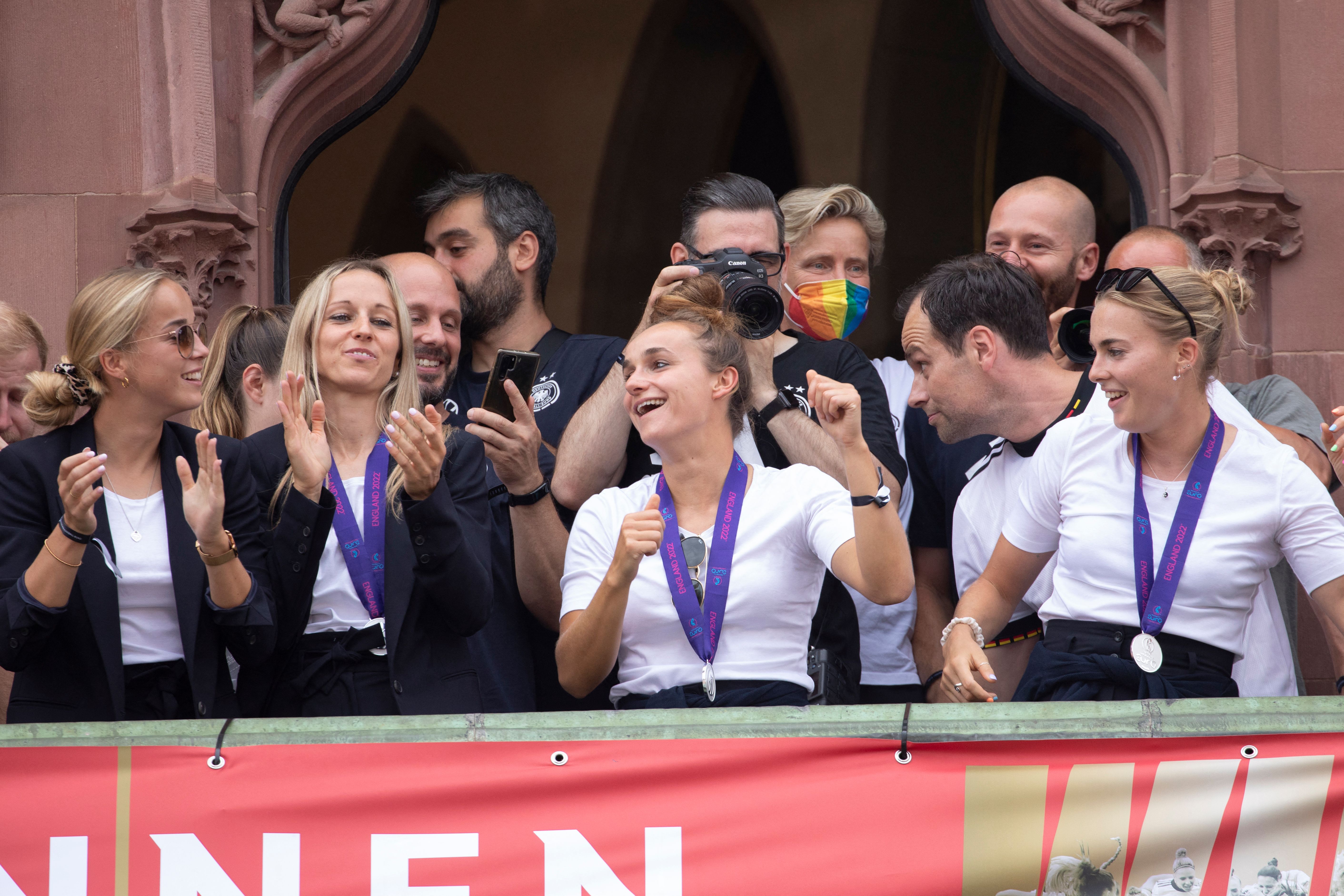 Germany women's team players on the balcony applauding as supporters receive them at Roemer square in Frankfurt