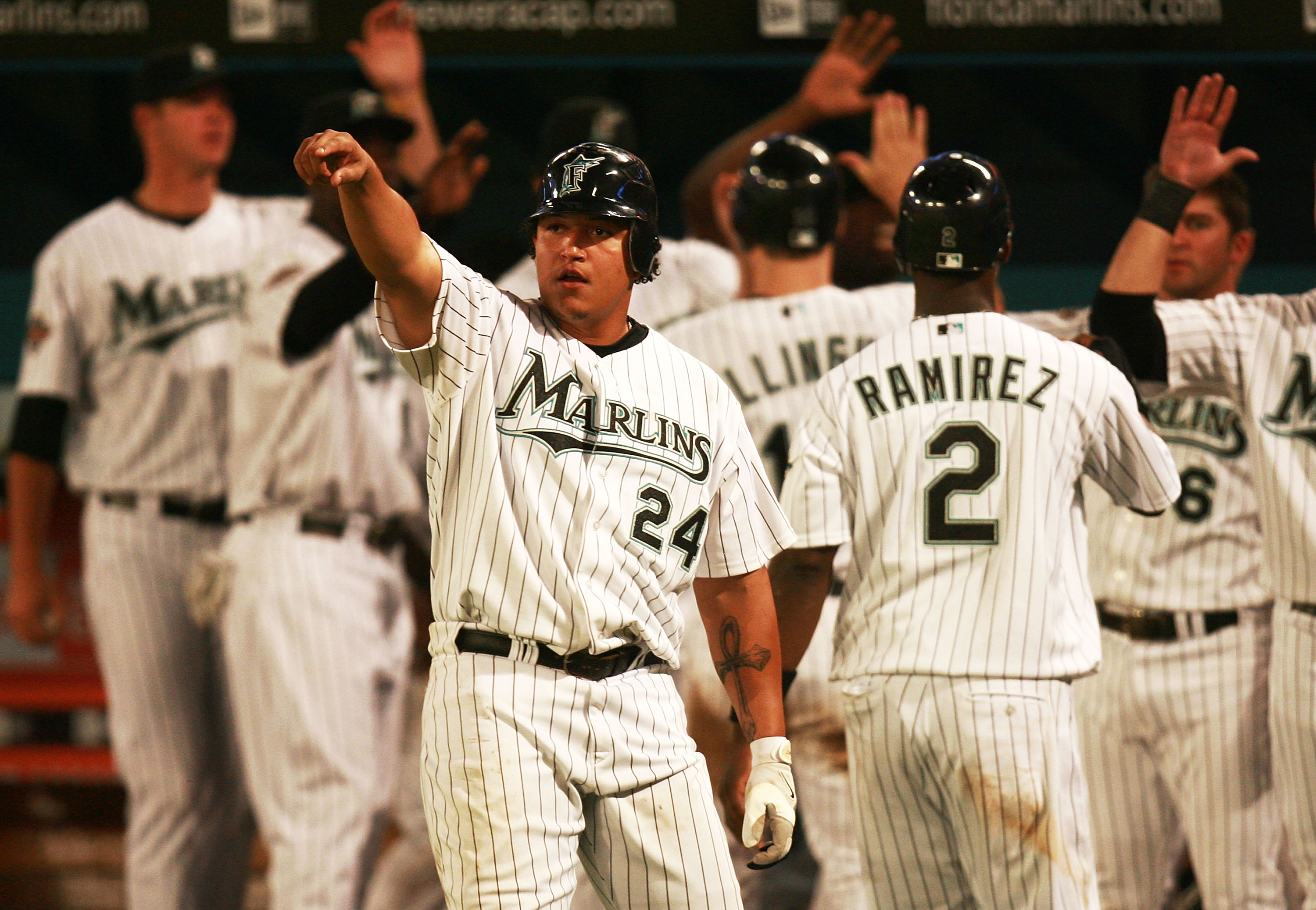 Miguel Cabrera #24 of the Florida Marlins points toward teammate Miguel Olivo #30 after Olivo hit a three-run double in the seventh inning against the Cleveland Indians during interleague play at Dolphin Stadium on June12, 2007 in Miami, Florida.