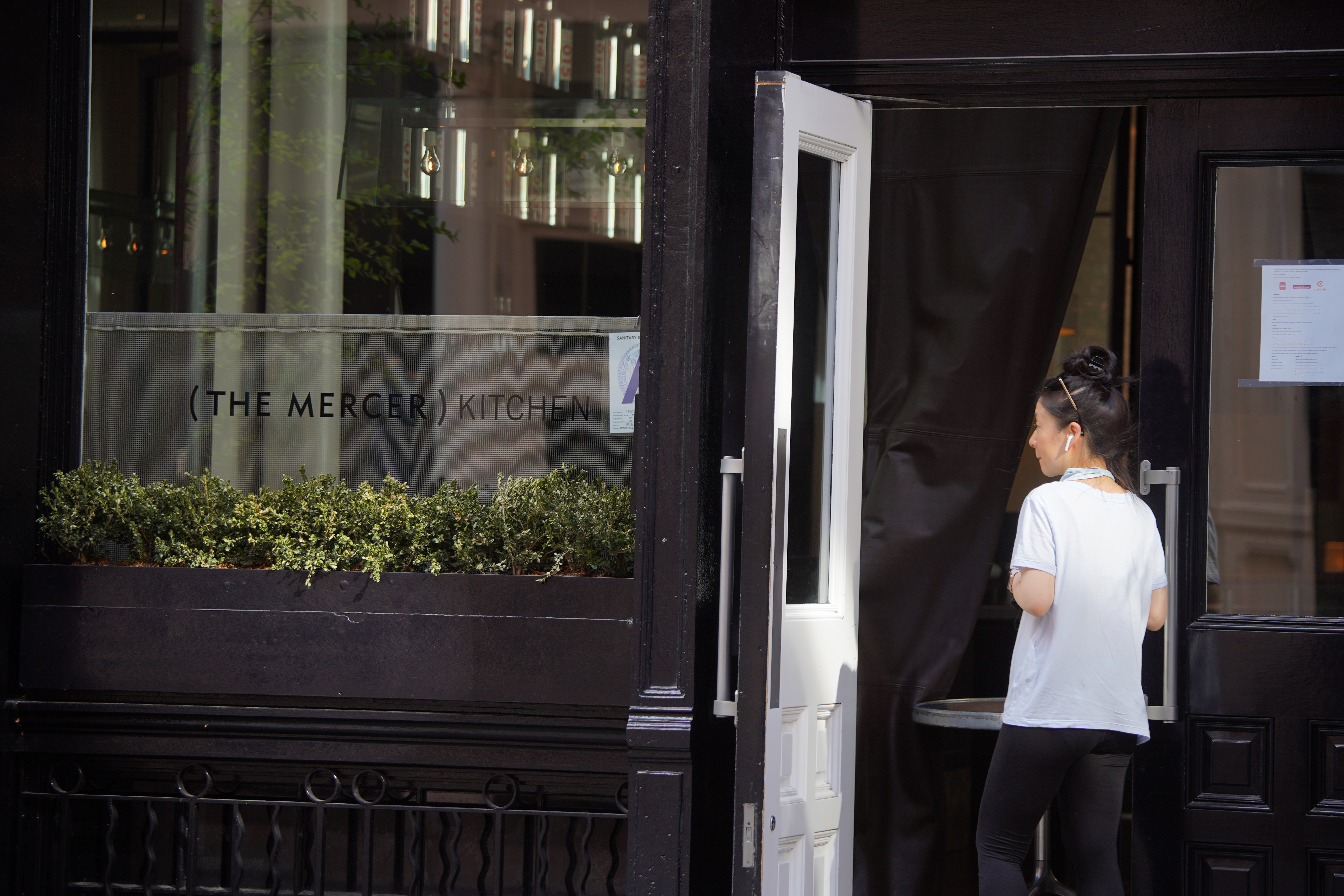 A person stands outside the Mercer Kitchen in the Soho section of Manhattan.