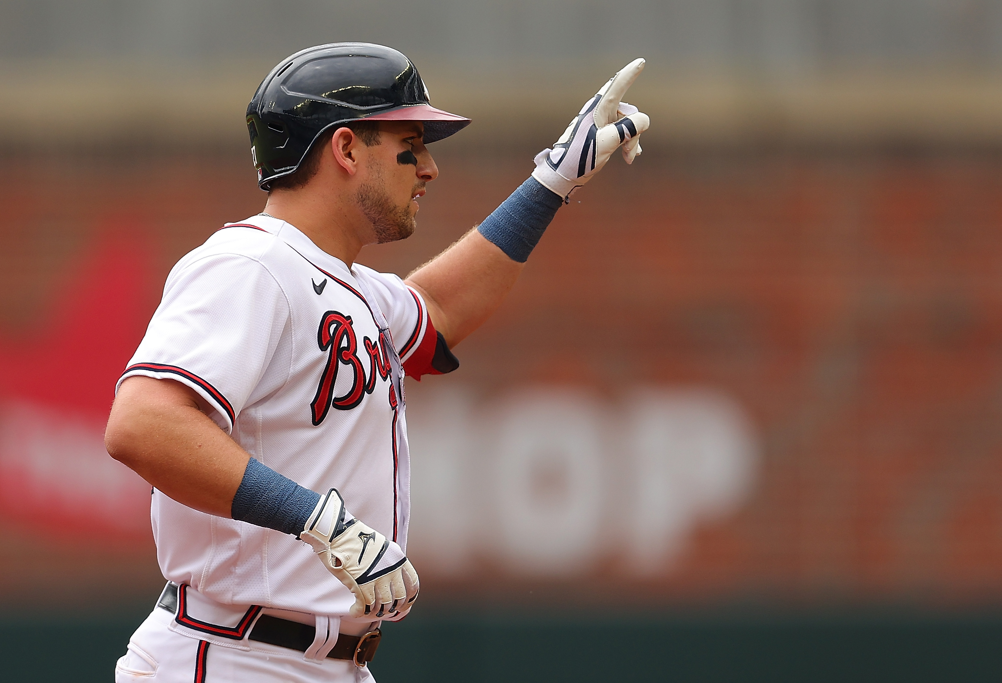 Austin Riley #27 of the Atlanta Braves reacts after hitting a double to lead off the second inning against the Philadelphia Phillies at Truist Park on August 03, 2022 in Atlanta, Georgia.