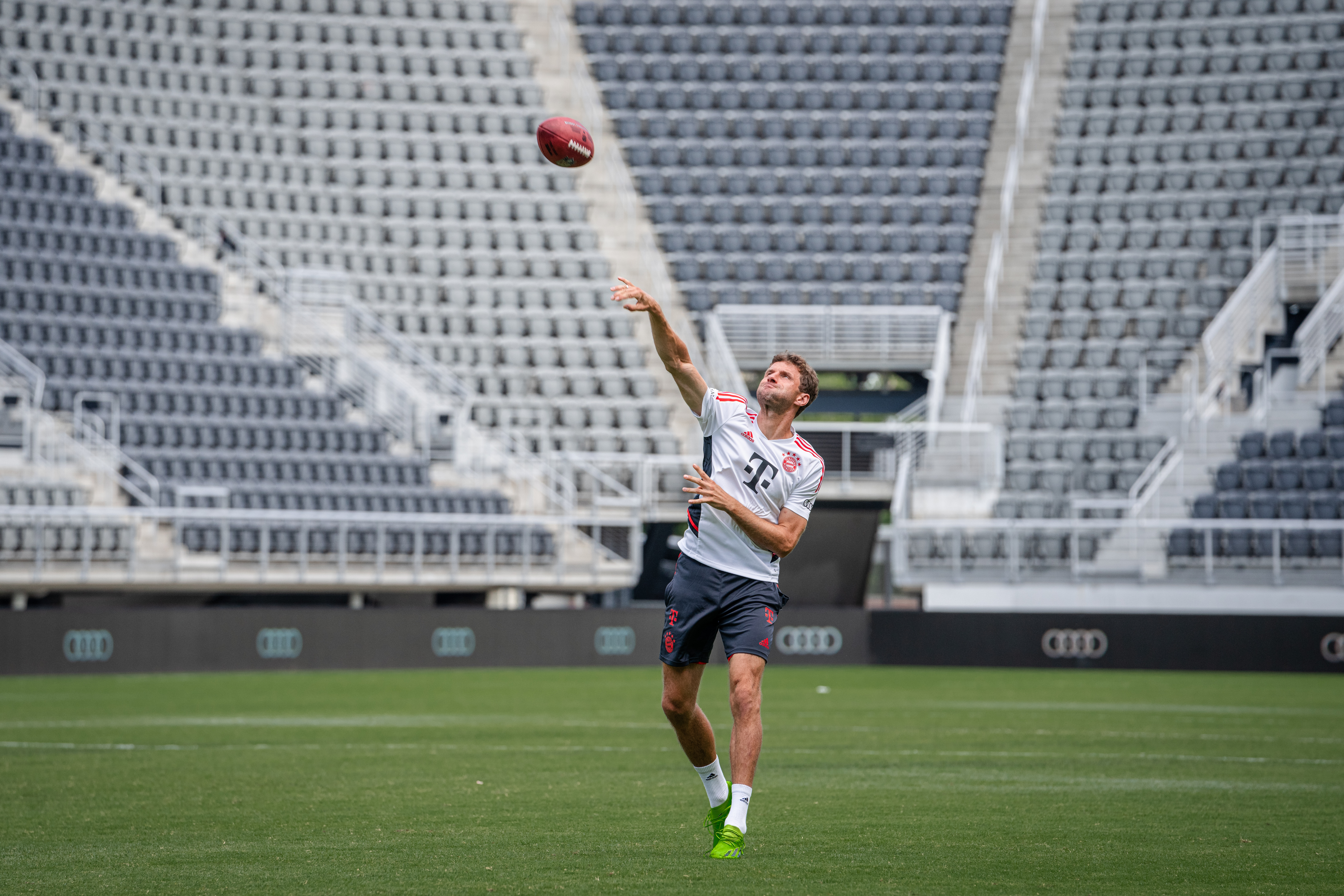 Müller, arm at full stretch, releases an American football during training in Washington, D.C.