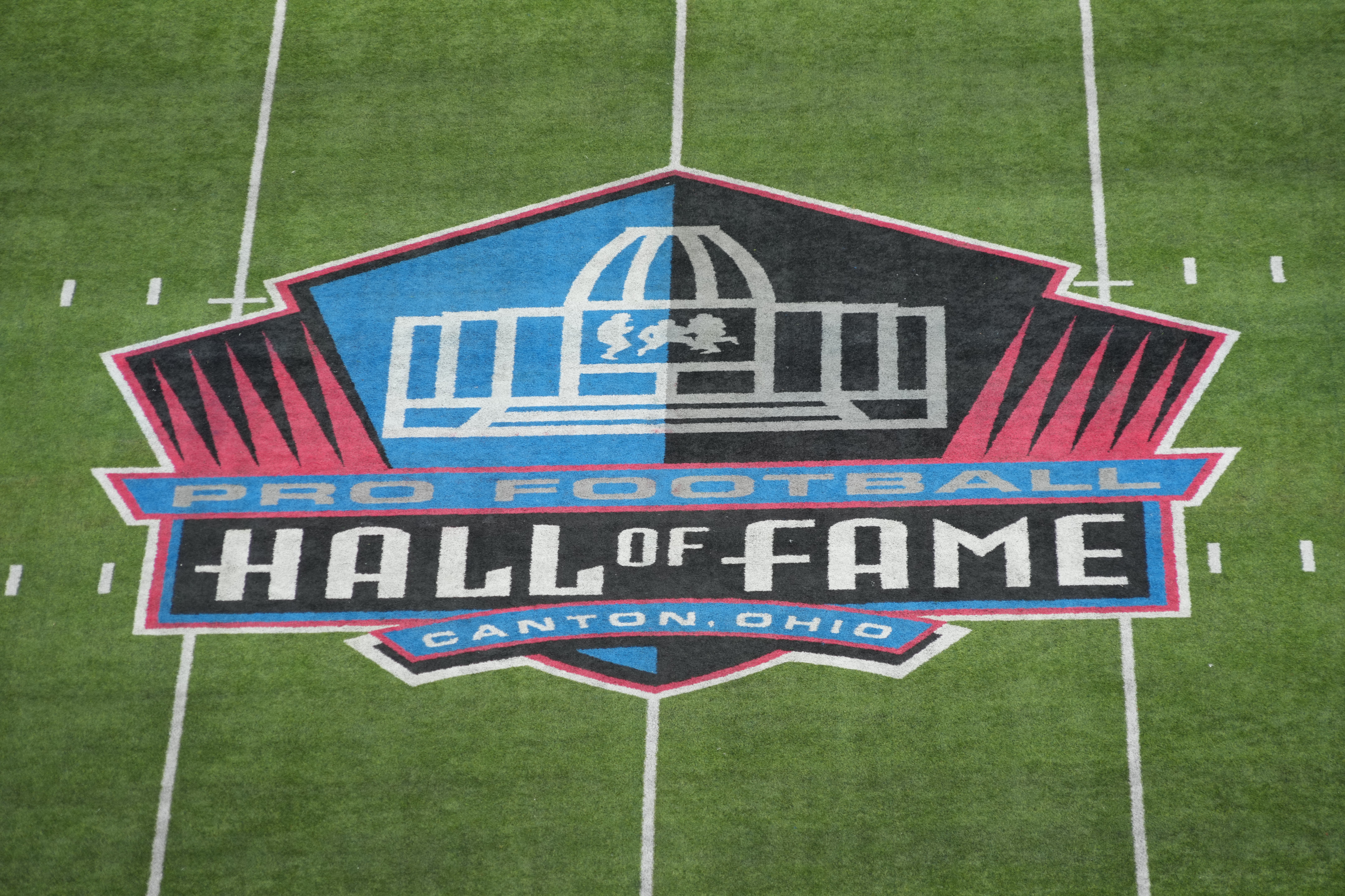 The Pro Football Hall of Fame logo at midfield at Tom Benson Hall of Fame Stadium.