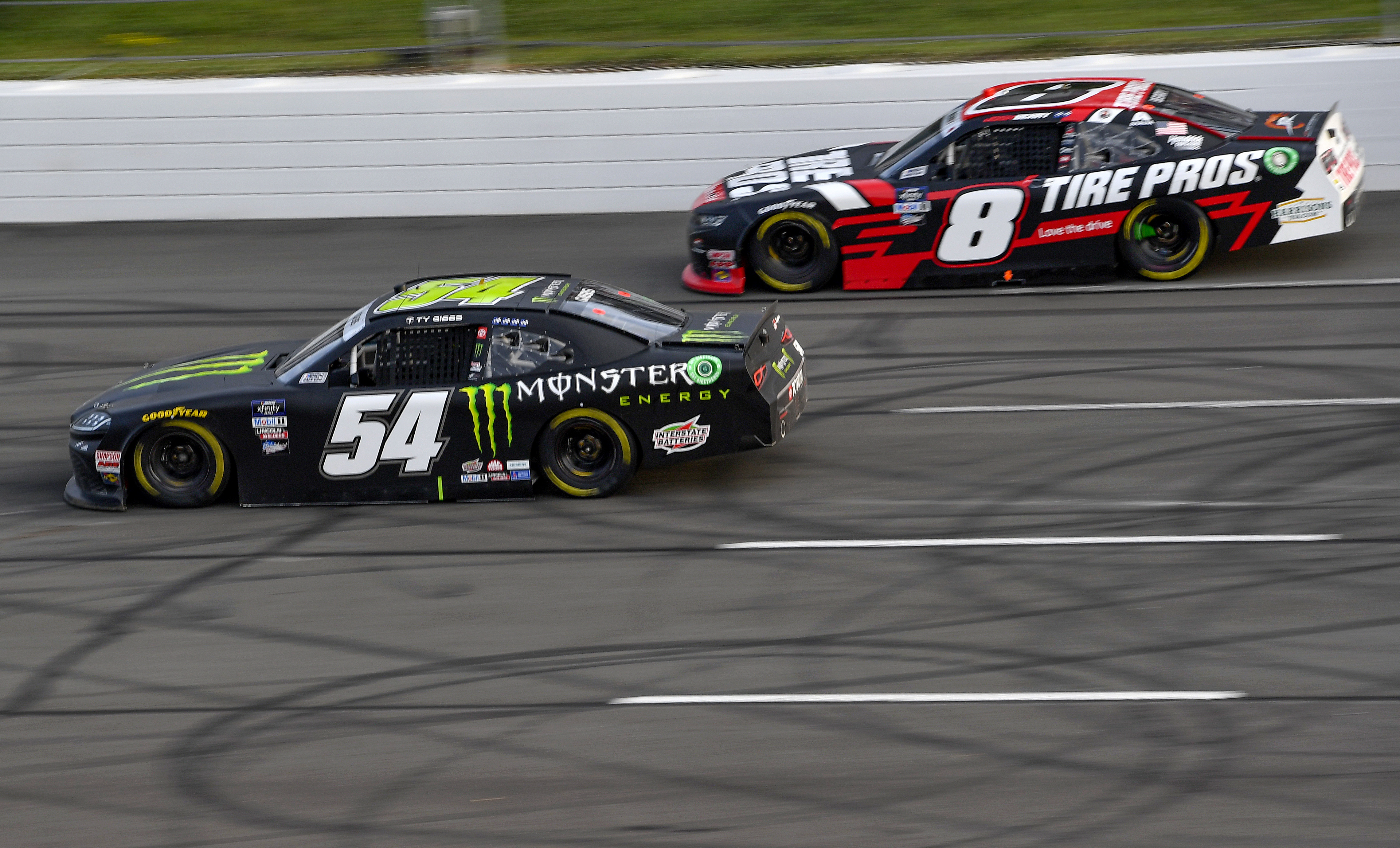 Ty Gibbs, driver of the #54 Monster Energy Toyota, and Josh Berry, driver of the #8 Tire Pros Chevrolet, race during the NASCAR Xfinity Series Explore the Pocono Mountains 225 at Pocono Raceway on July 23, 2022 in Long Pond, Pennsylvania.