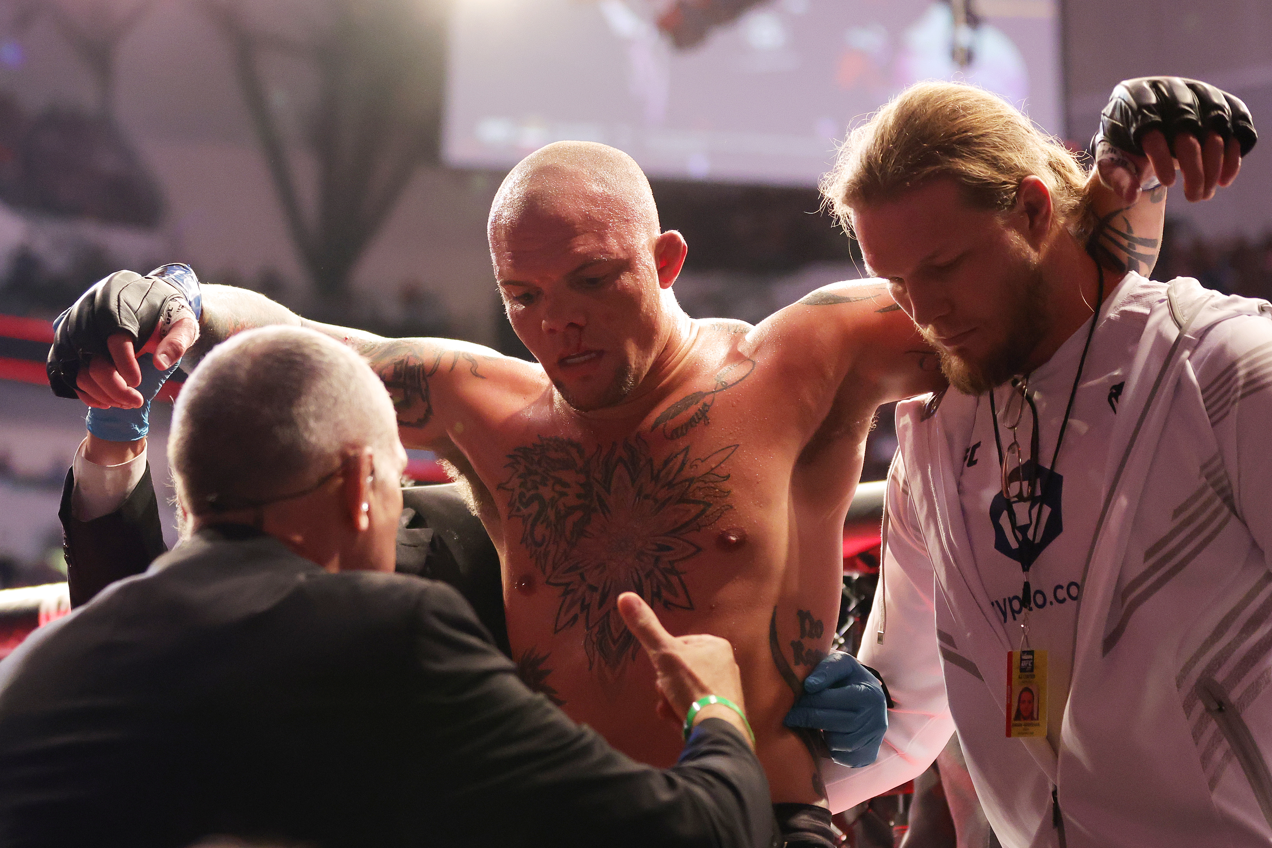 Anthony Smith being helped out of the Octagon at UFC 277. 