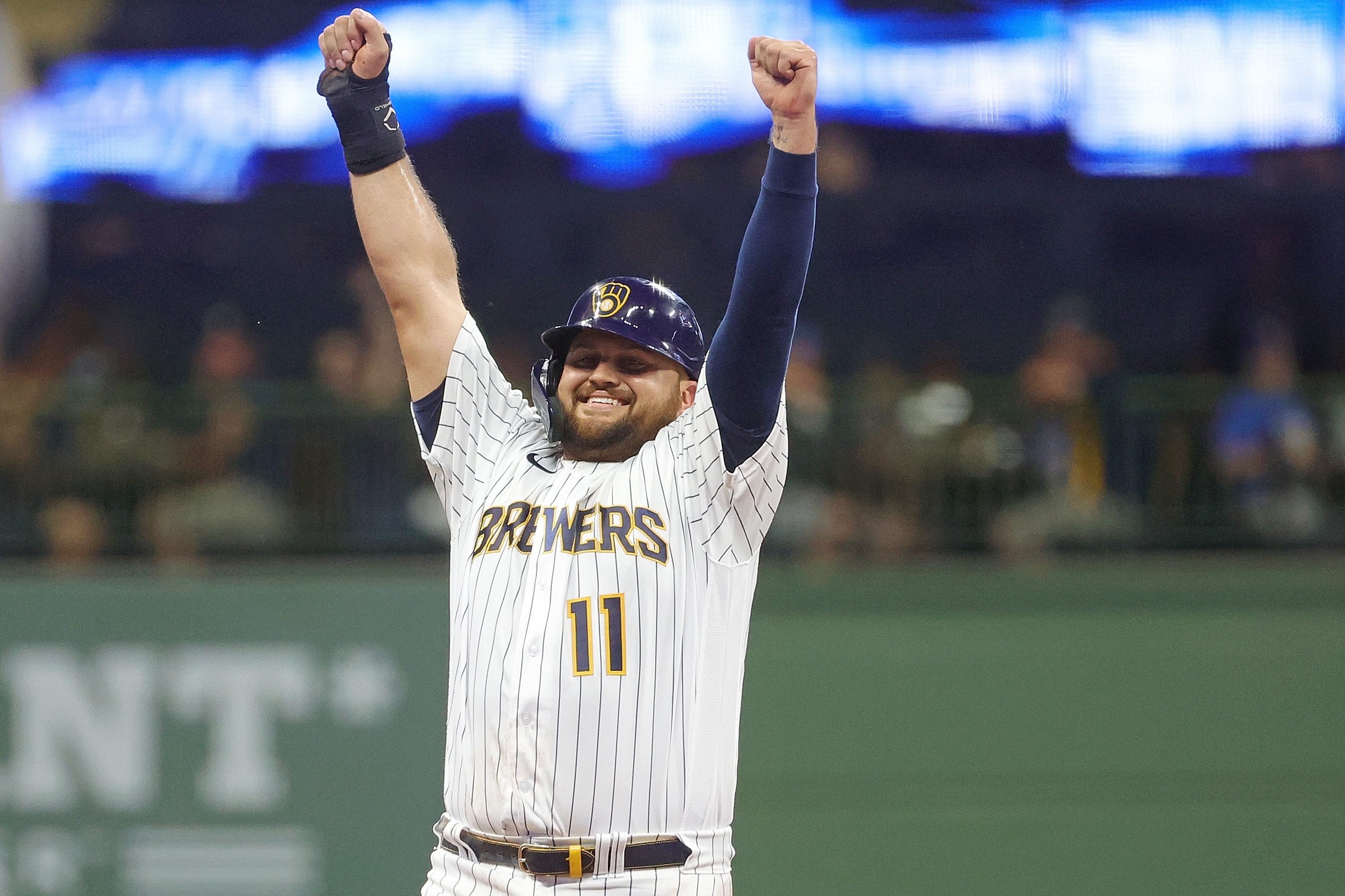 Rowdy Tellez #11 of the Milwaukee Brewers reacts after stealing second base during the third inning against the Cincinnati Reds at American Family Field on August 05, 2022 in Milwaukee, Wisconsin.