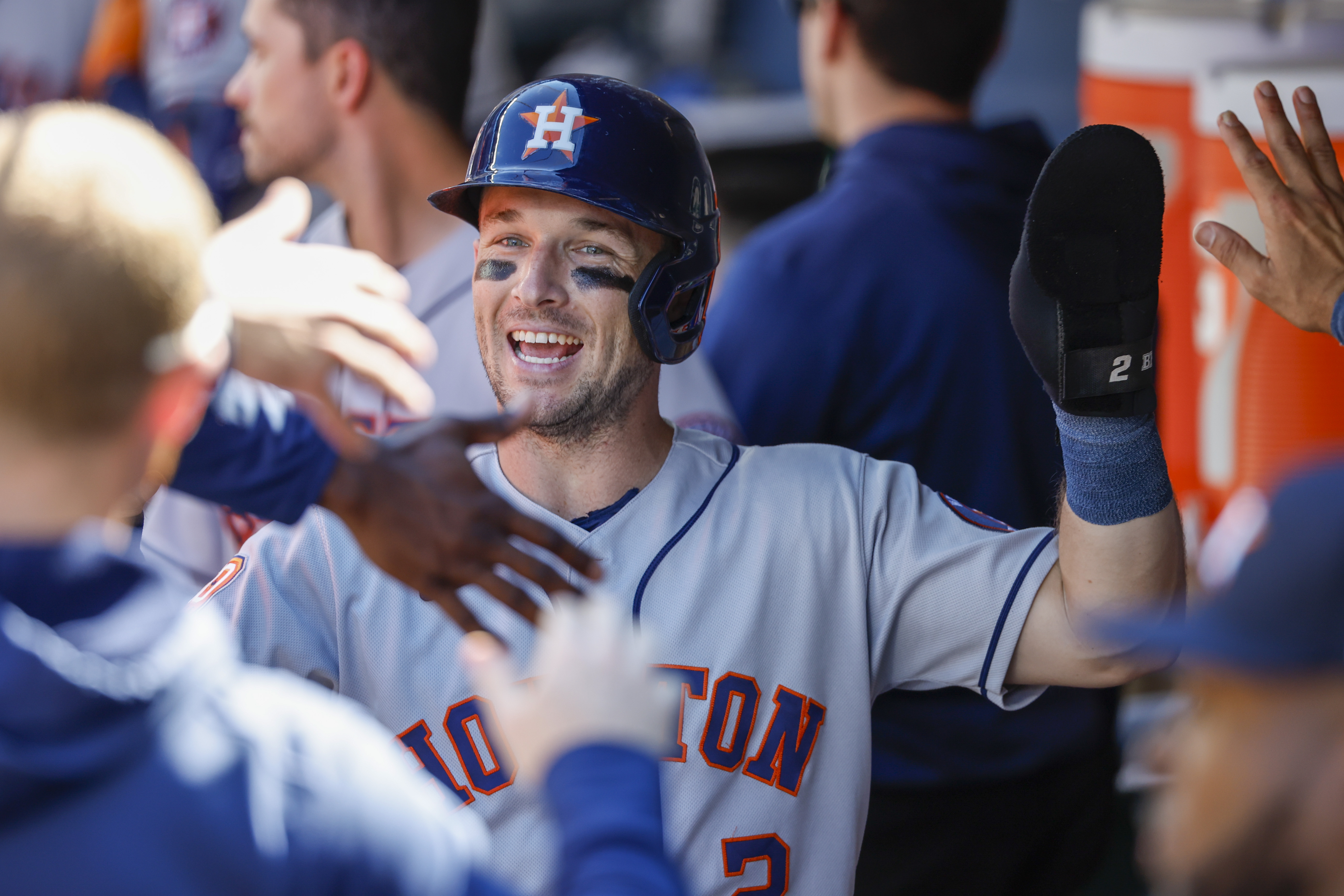 Houston Astros third baseman Alex Bregman (2) high-fives teammates in the dugout after scoring a run against the Seattle Mariners during the eighth inning at T-Mobile Park.