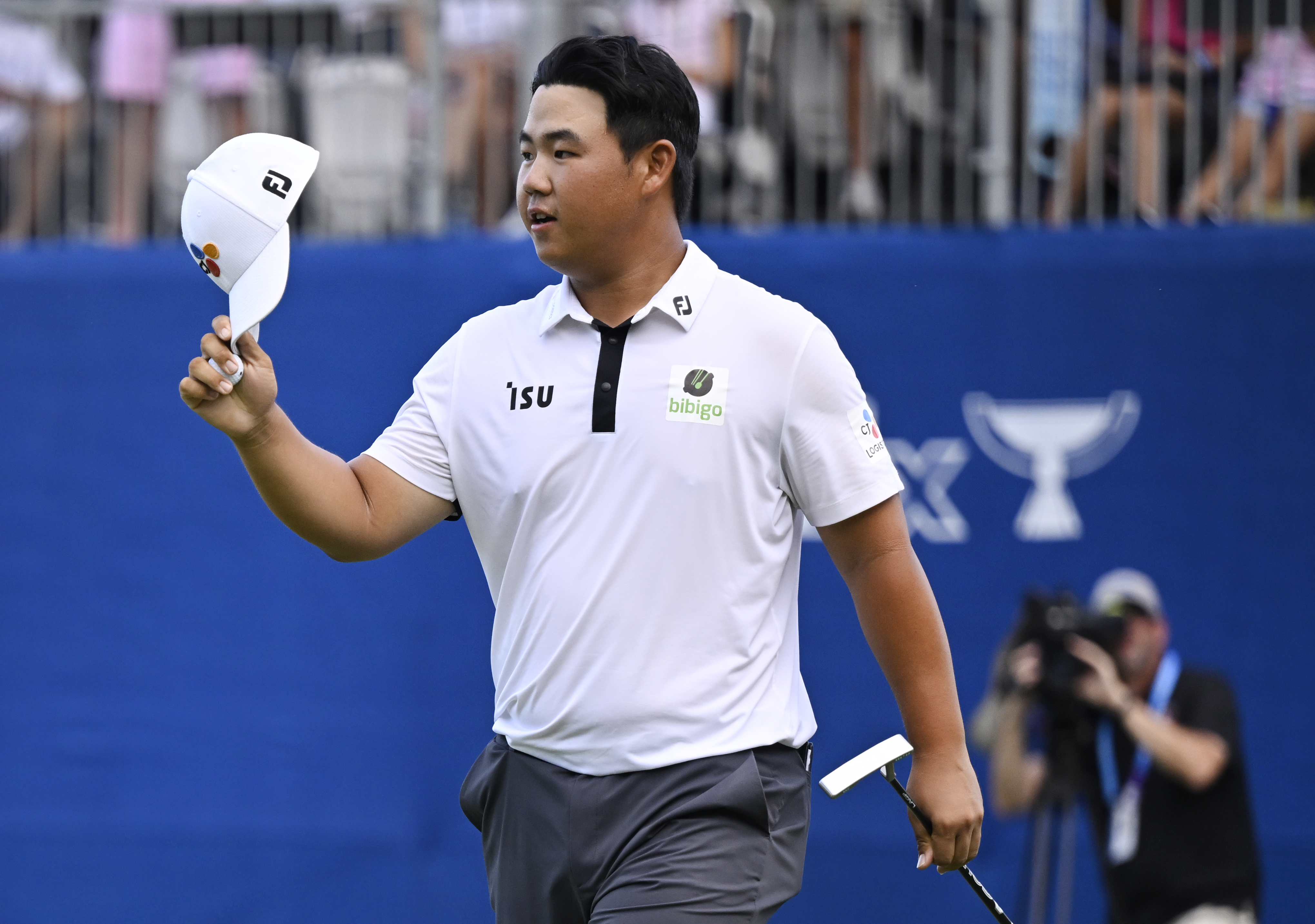 Joohyung Kim of Korea celebrates after putting in to win on the 18th green during the final round of the Wyndham Championship at Sedgefield Country Club on August 07, 2022 in Greensboro, North Carolina.