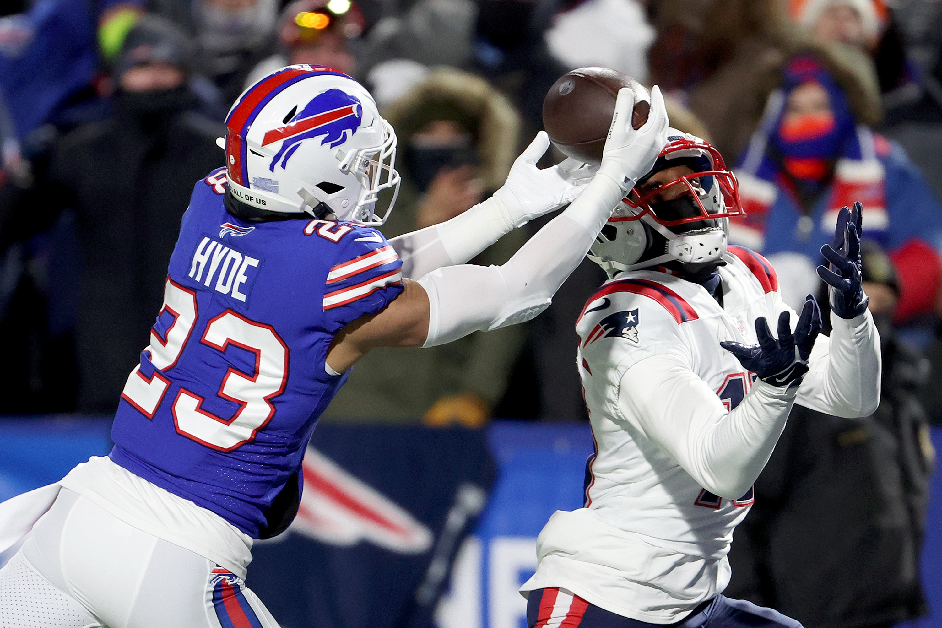 Micah Hyde #23 of the Buffalo Bills intercepts a pass intended for Nelson Agholor #15 of the New England Patriots during the first quarter in the AFC Wild Card playoff game at Highmark Stadium on January 15, 2022 in Buffalo, New York.